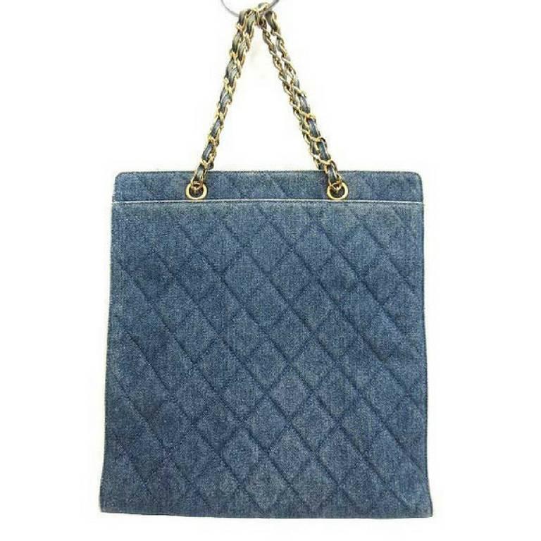 1990s. Vintage CHANEL quilted denim vertical square shoulder tote bag with gold tone chain straps and CC closure. Classic bag. Must have.

Introducing another fab and mod classic vintage CHANEL bag in denim fabric. 
Featuring its iconic golden CC