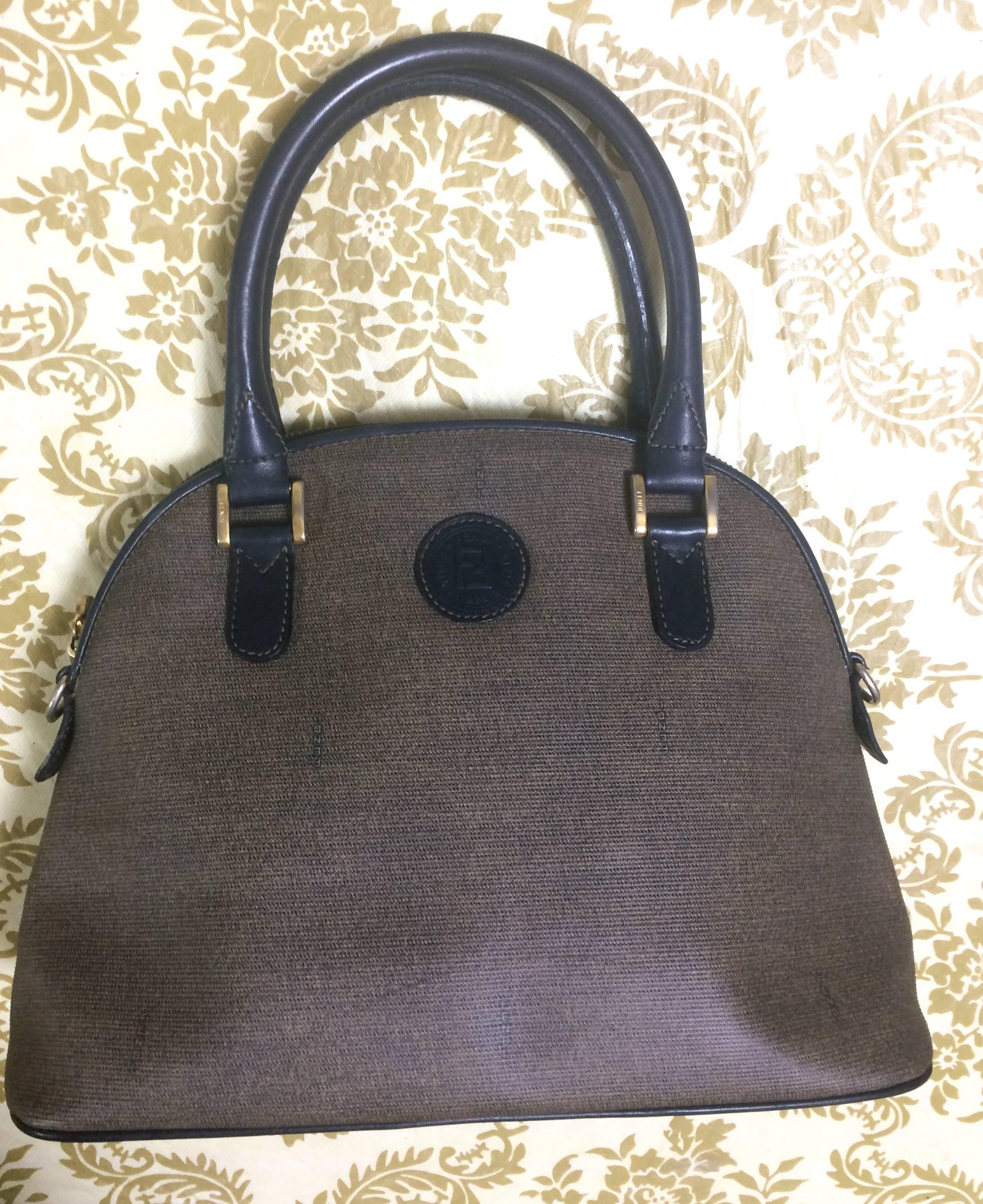 1990s. Vintage FENDI classic black and grey pecan vertical stripe bolide shape handbag with leather handles. Classic bag for daily use.

Here is another classic FENDI purse, iconic pecan pattern bag in bolide shape from the 90's. 
Very classic and