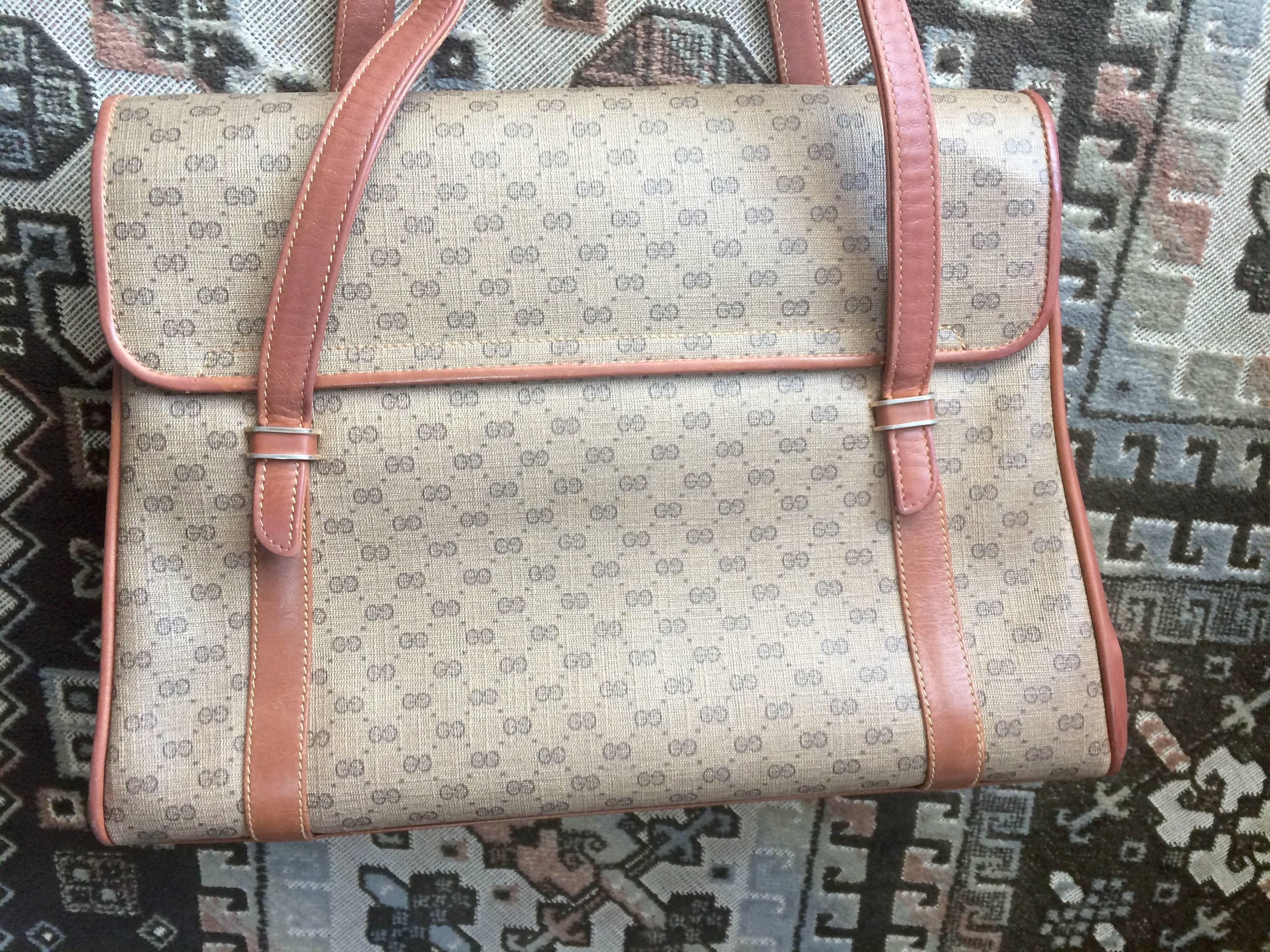 1980s. Vintage Gucci beige micro GG monogram print shoulder bag with brown leather trimmings. Classic purse. 

Here is another vintage Gucci classic bag from the 80's.
Featuring micro GG print all over. 

The oval GG logo plate at the front flap,