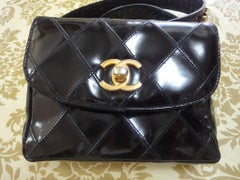 Vintage CHANEL black patent enamel waist purse, fanny pack with gold chain belt.