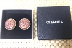 Vintage CHANEL brown candy earrings with  gold tone frame and engraved logo.