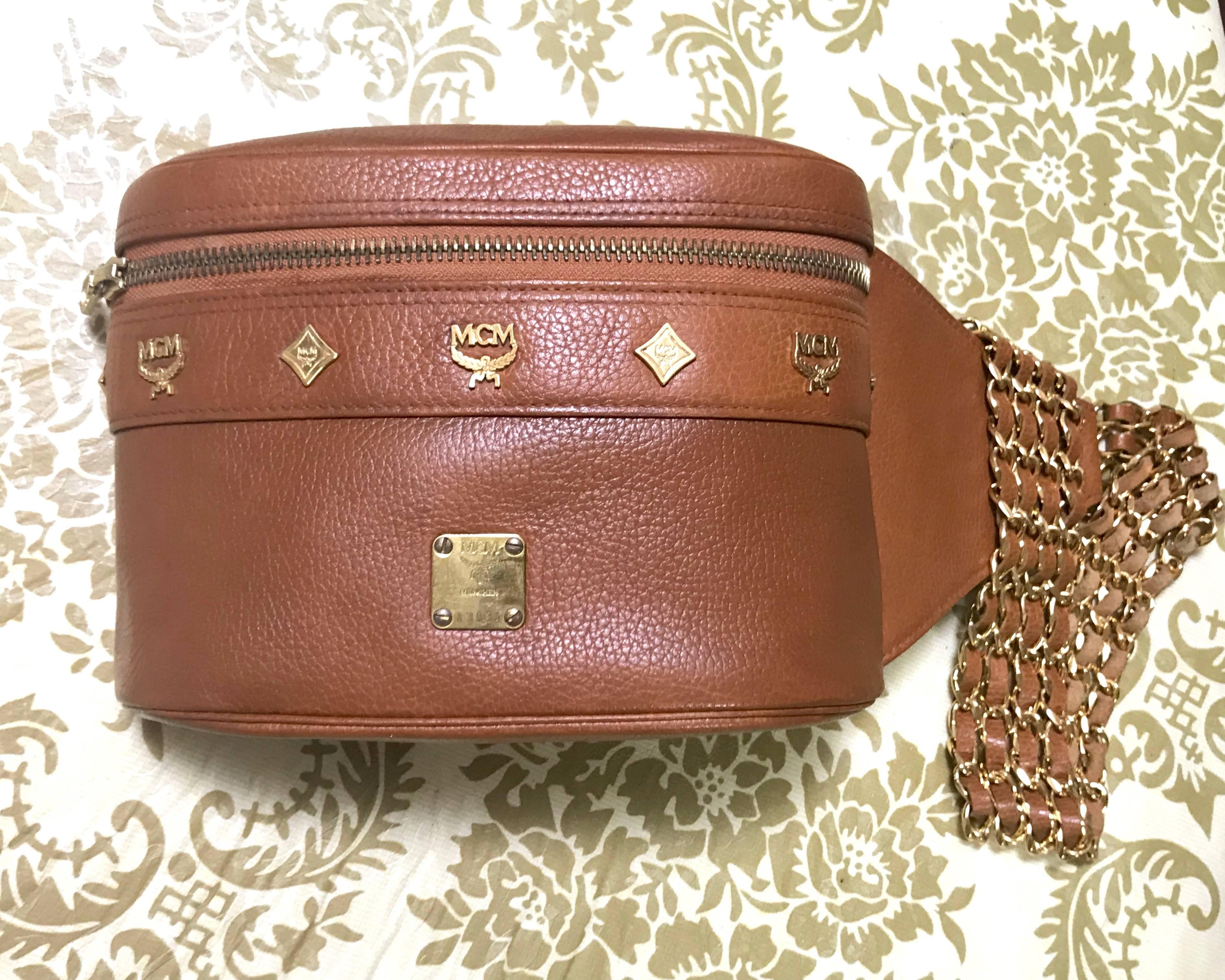 1990s. Vintage MCM brown leather fanny pack with multiple layer golden chain and leather belt with logo studded motifs. Rare masterpiece. Unisex


Introducing another rare masterpiece from MCM back in the late 80's through early 90's.
Rare brown