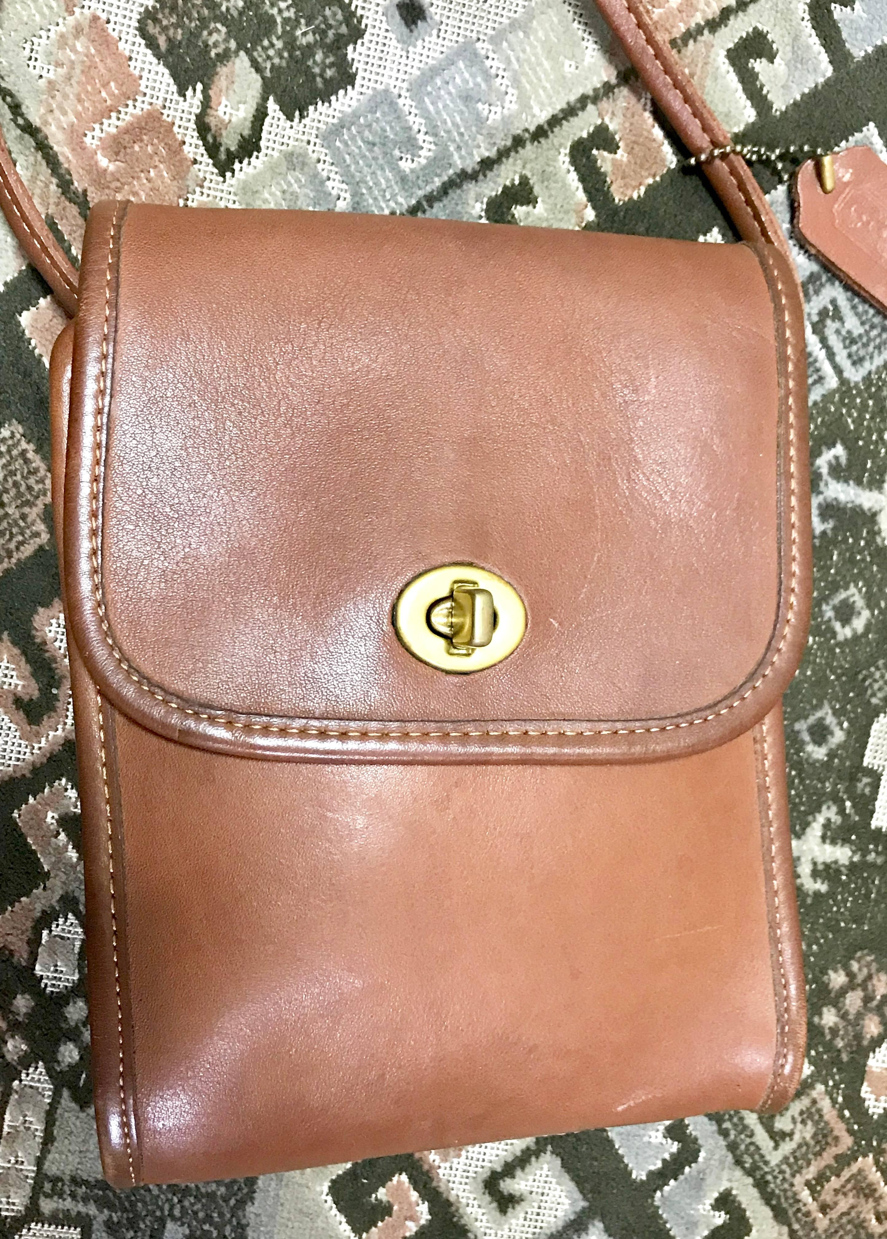 1980s. Vintage COACH genuine brown leather mini shoulder bag vertical rectangular shape. classic purse. Made in USA

This is a vintage piece of COACH in the 80’s. 
Genuine leather and simple silhouette but remains a warmness of atmosphere back in