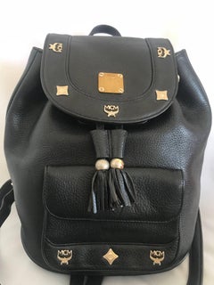 Vintage MCM black backpack with golden studded motifs, by Michael Cromer