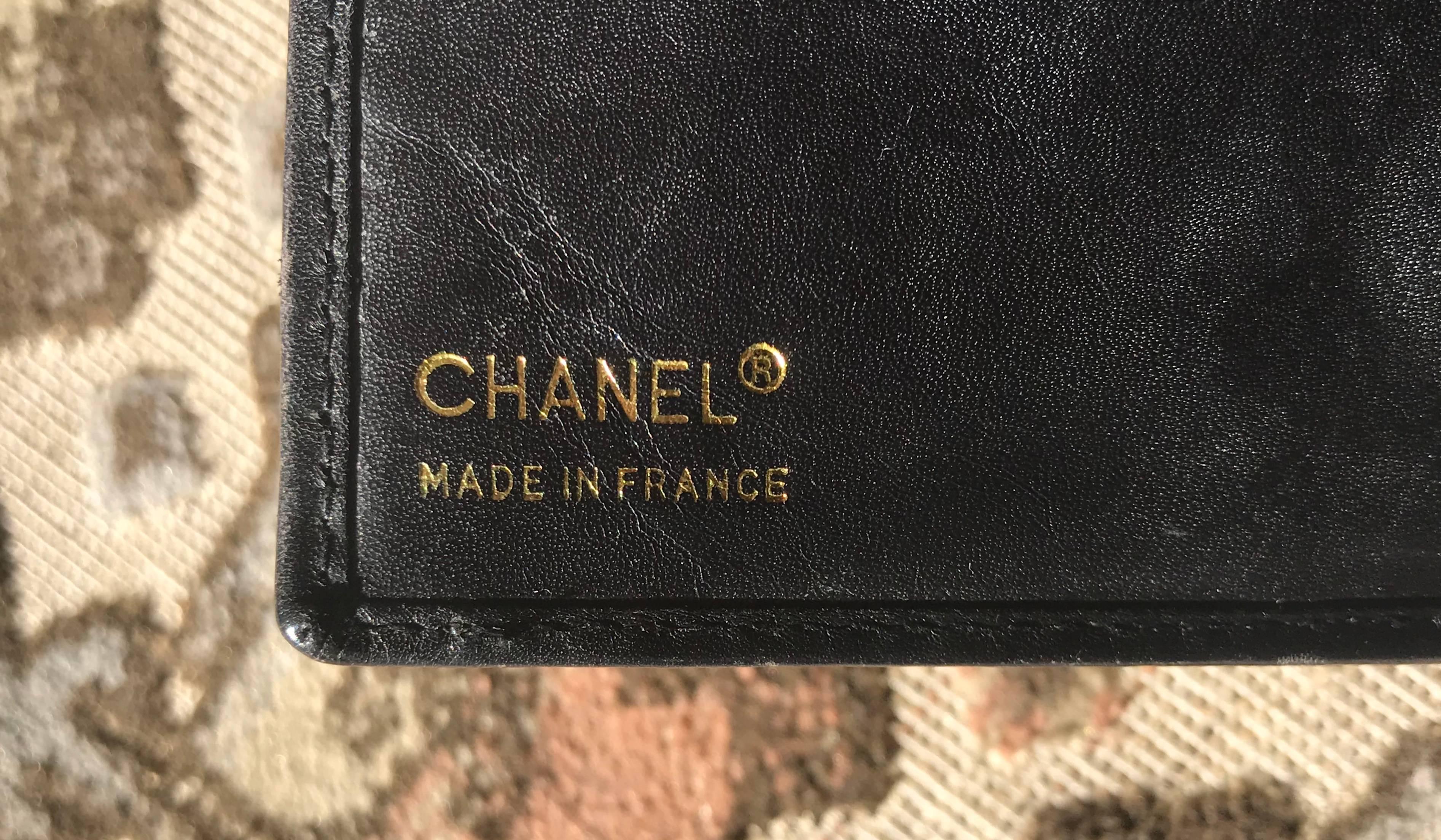Vintage CHANEL black leather wallet with large CC stitch mark.  1