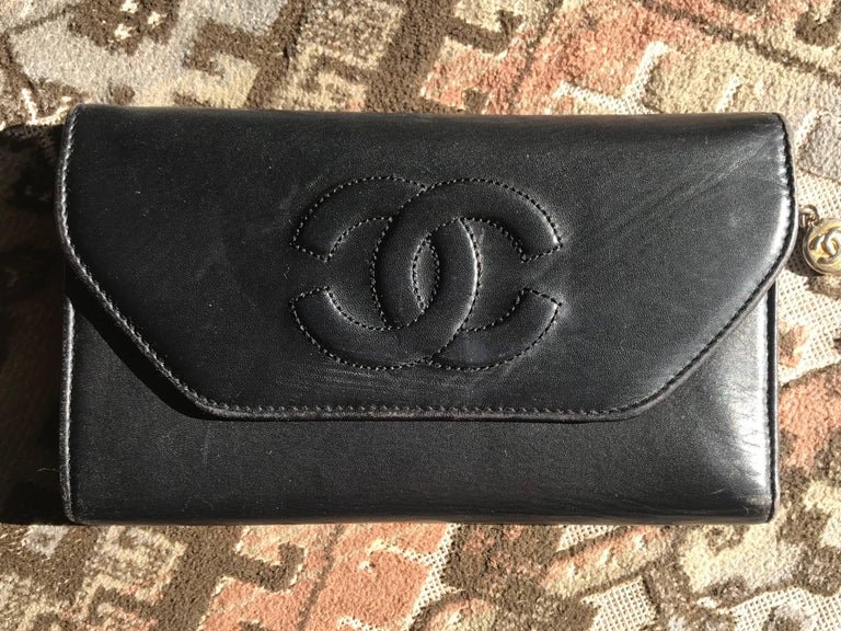 Vintage CHANEL black leather wallet with large CC stitch mark. at 1stDibs