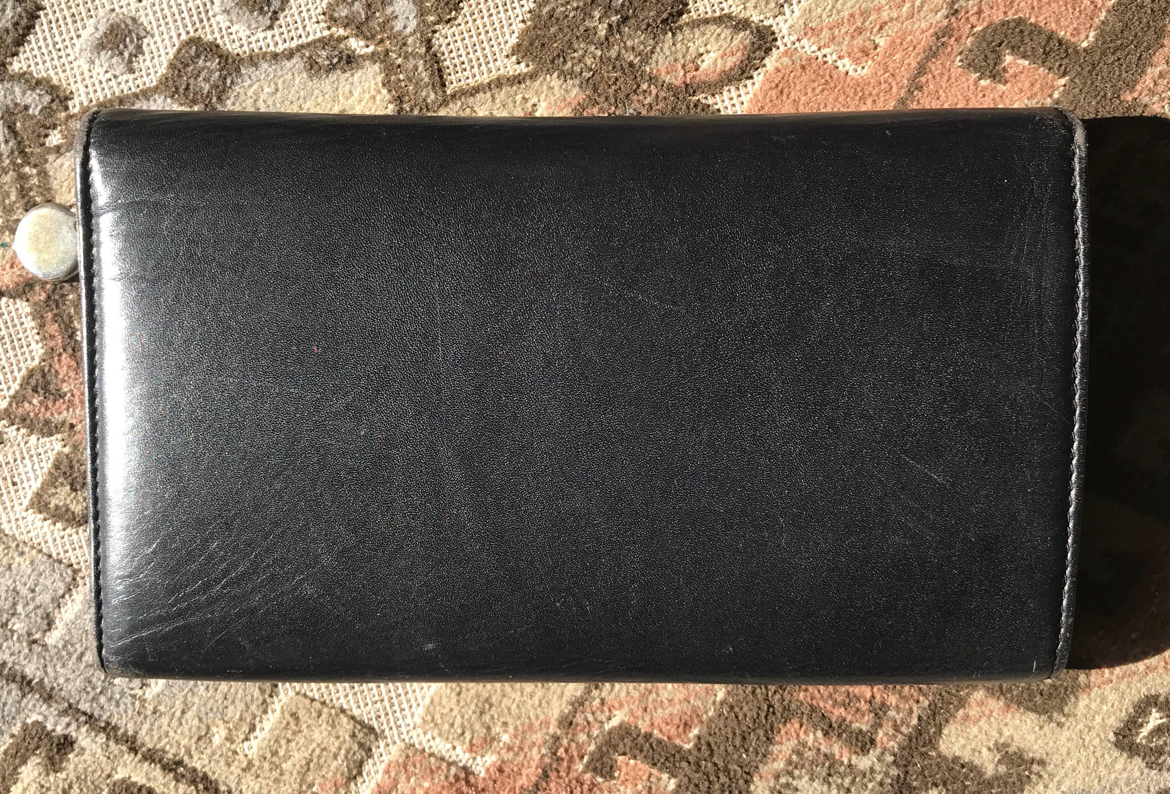 Black Vintage CHANEL black leather wallet with large CC stitch mark. 