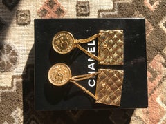 Vintage CHANEL classic 2.55 bag design dangling earrings with CC mark.