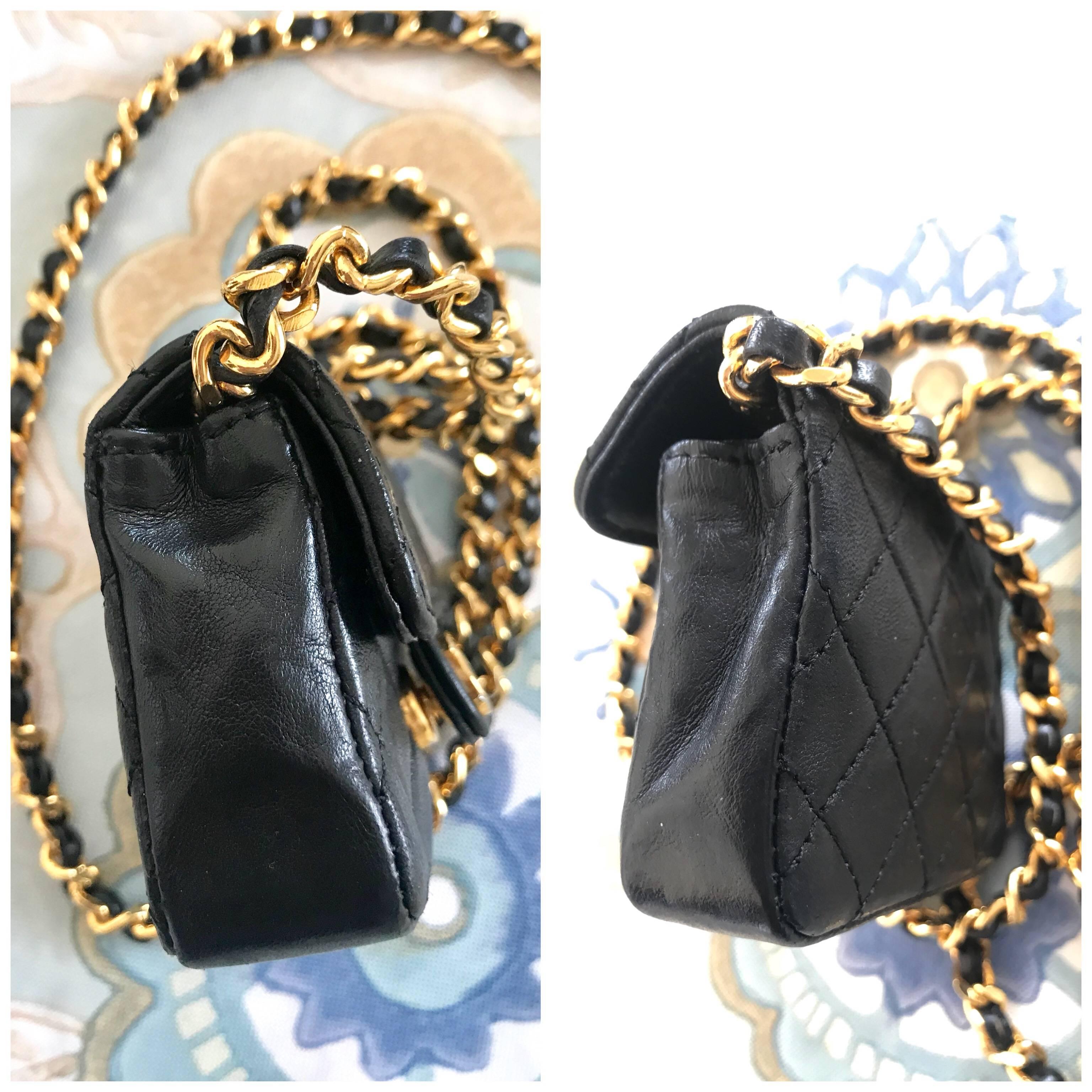 Women's or Men's Vintage Chanel black mini 2.55 bag/necklace with long chain and leather strap.