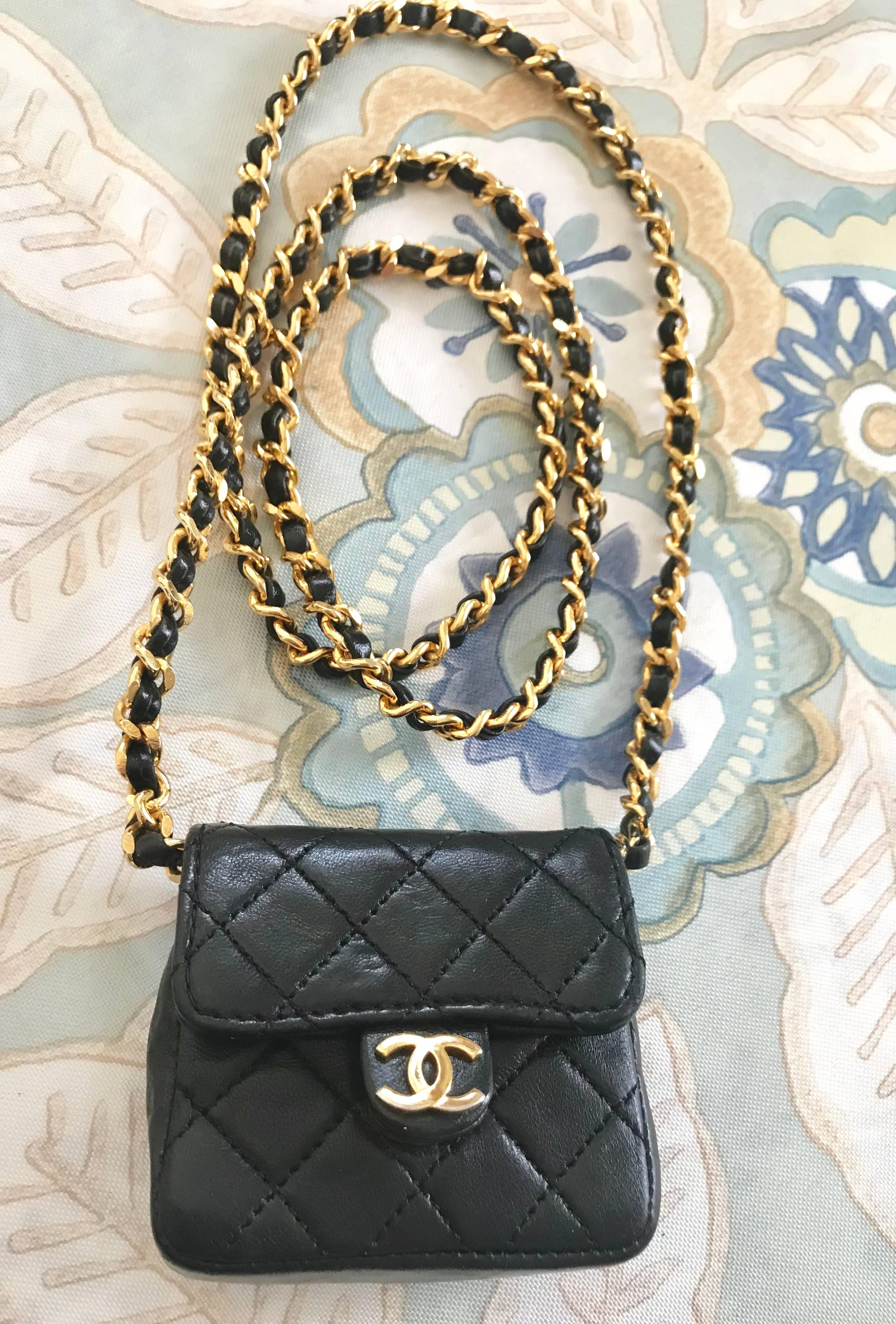 1990s. Vintage CHANEL black lambskin mini 2.55 bag/necklace with golden chain and leather long strap and golden CC motif. Must have.

Here is another fabulous piece from CHANEL back in the era of early 90's, a black leather mini 2.55 design purse