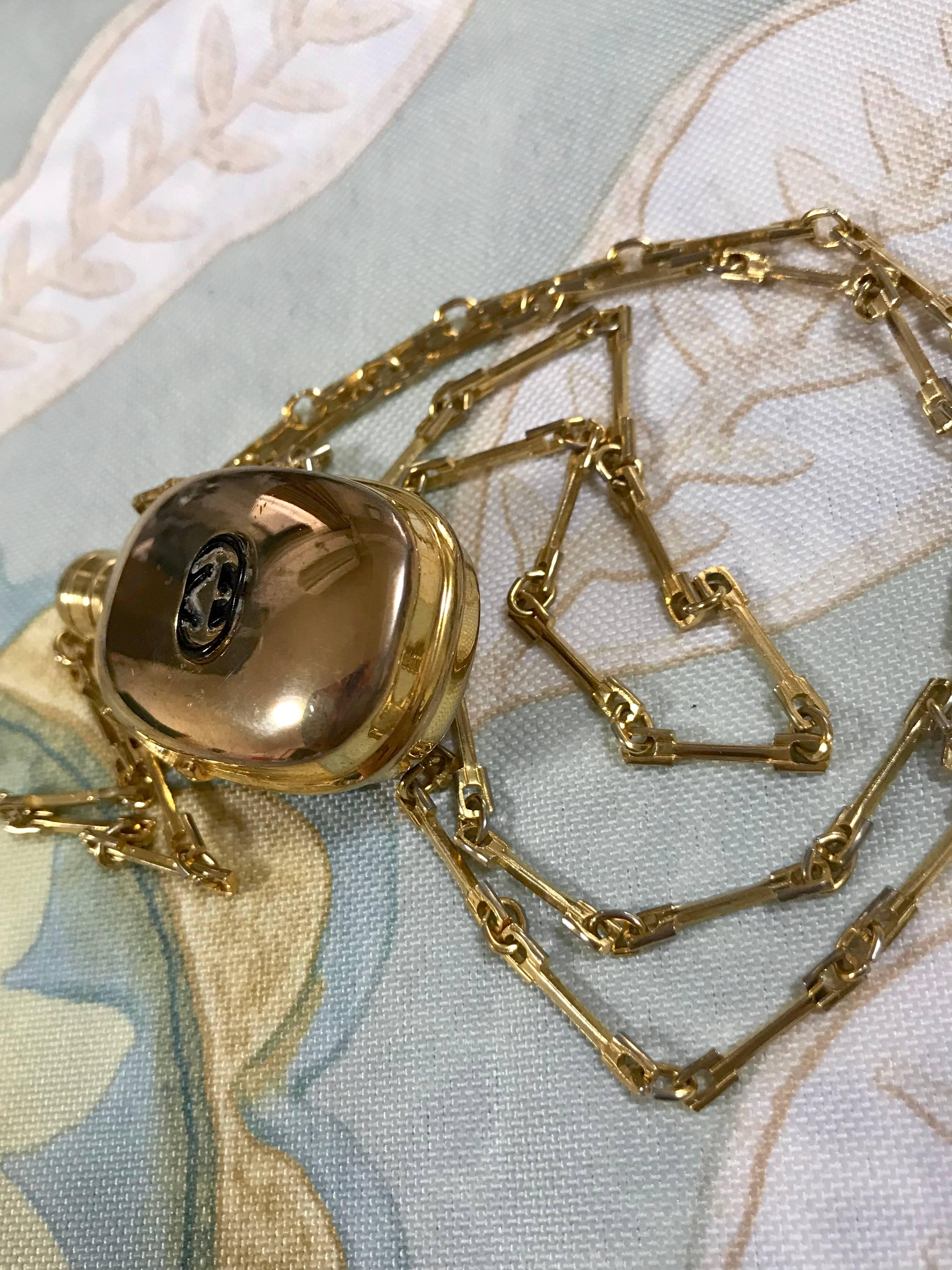 Vintage Gucci golden perfume bottle necklace with logo mark on top.  1