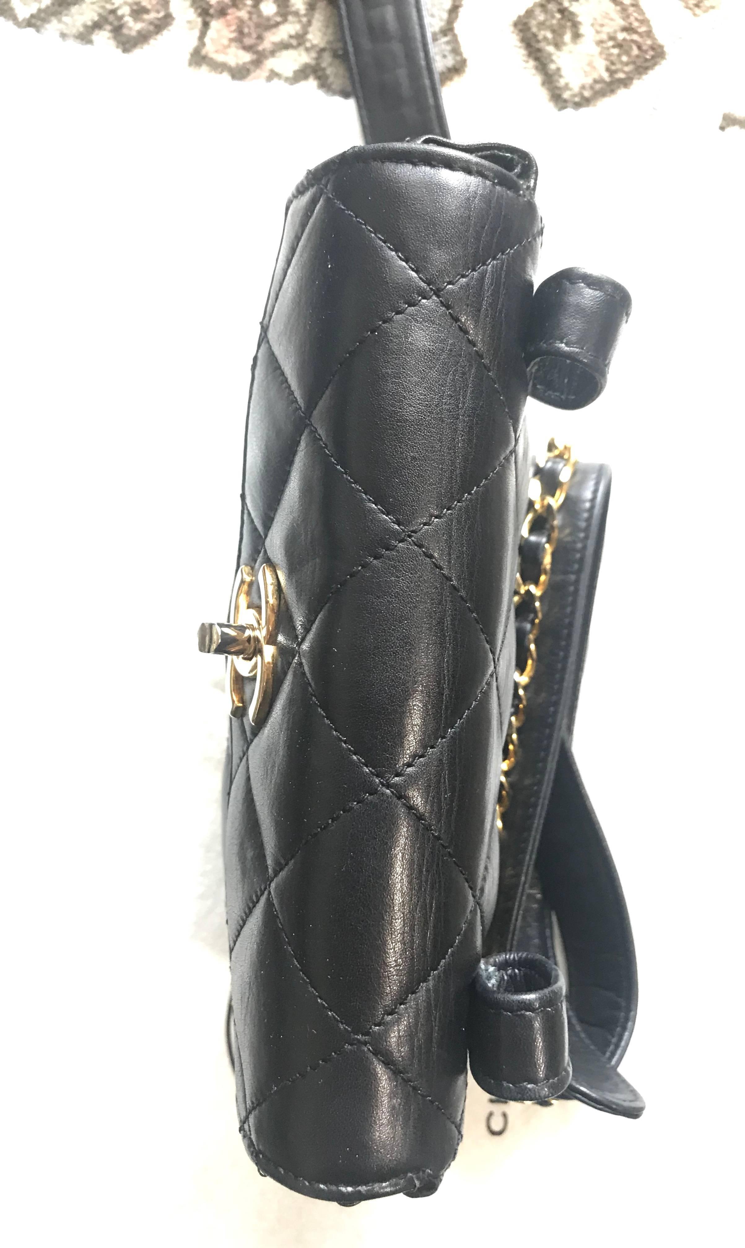 Women's Vintage CHANEL black lamb waist bag, fanny pack with golden chain belt & CC.