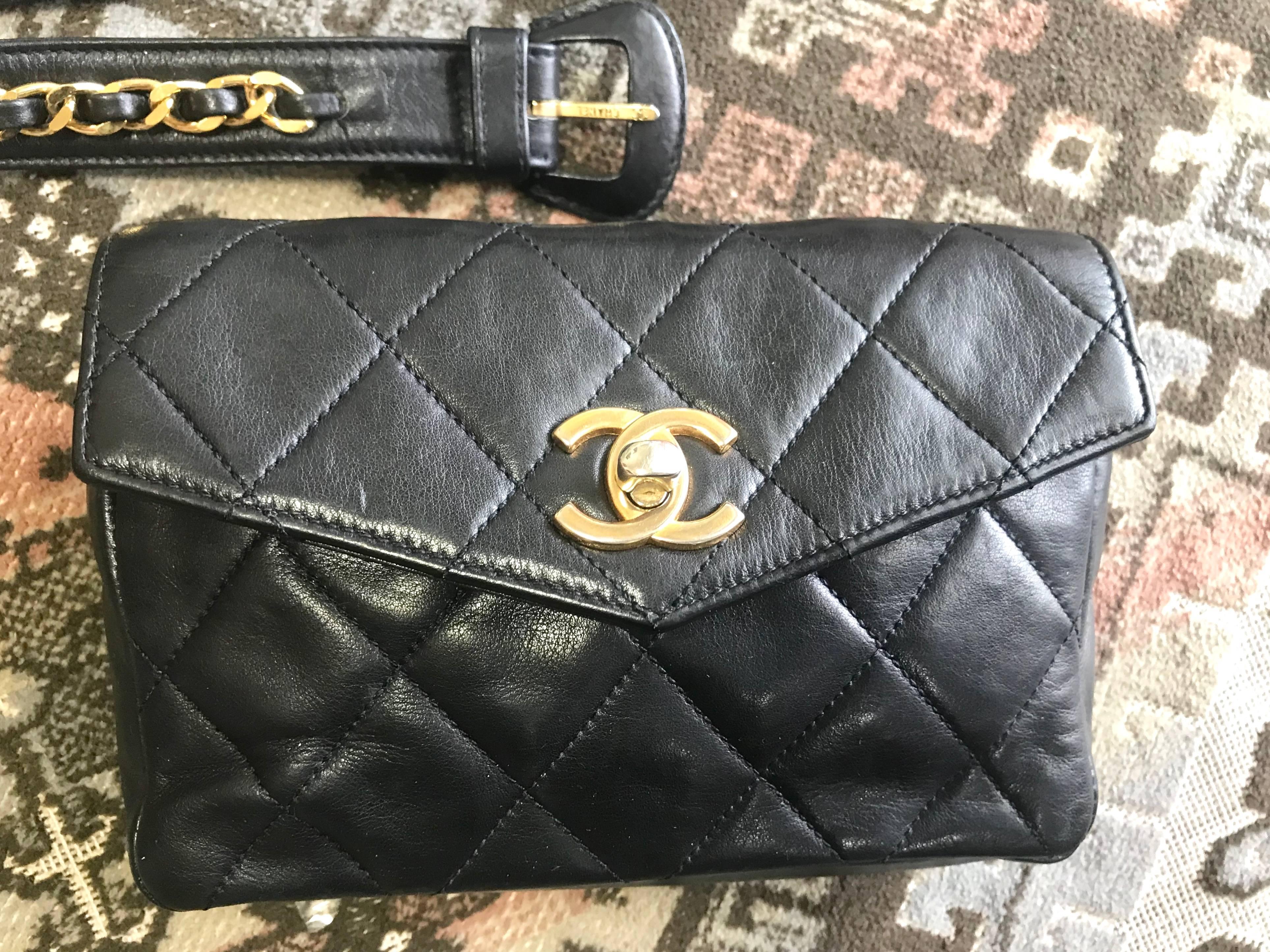 1980s. Vintage CHANEL black lamb leather waist bag, fanny pack with golden chain belt & CC closure. Belt size good for 24