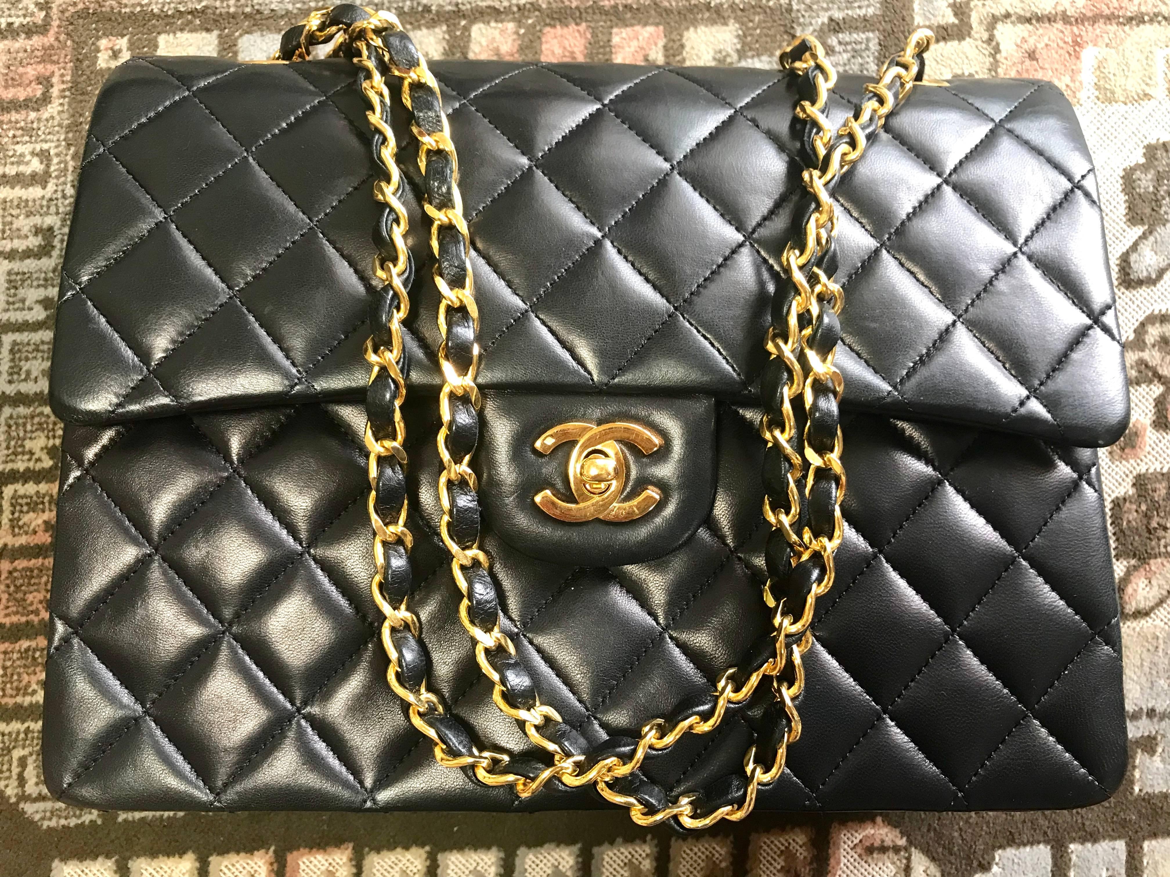 1980s. MINT/Excellent condition. Vintage CHANEL black lambskin classic 2.55 double flap shoulder purse with gold tone chain straps. Make you even more chic.


Introducing another vintage piece, a classic black lamb leather 2.55 double flap purse