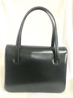 Vintage LANVIN black leather handbag with golden logo motif. Classic purse.