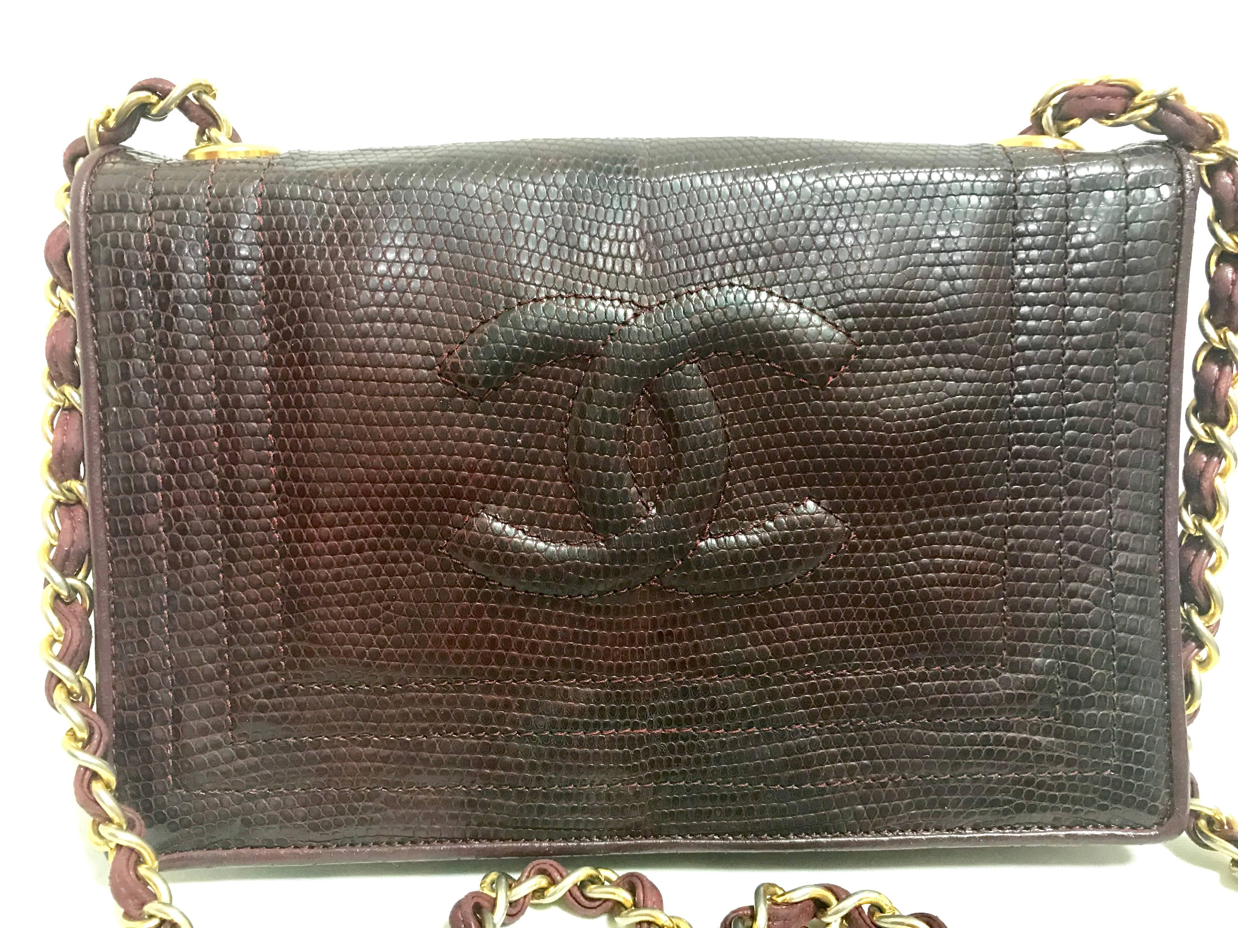 1980s. Vintage CHANEL genuine dark wine brown lizard  leather chain shoulder bag with CC stitch mark. Classic rectangle purse.

Here is another rare vintage CHANEL piece, dark wine brown genuine lizard leather purse with gold tone chain strap. 
If