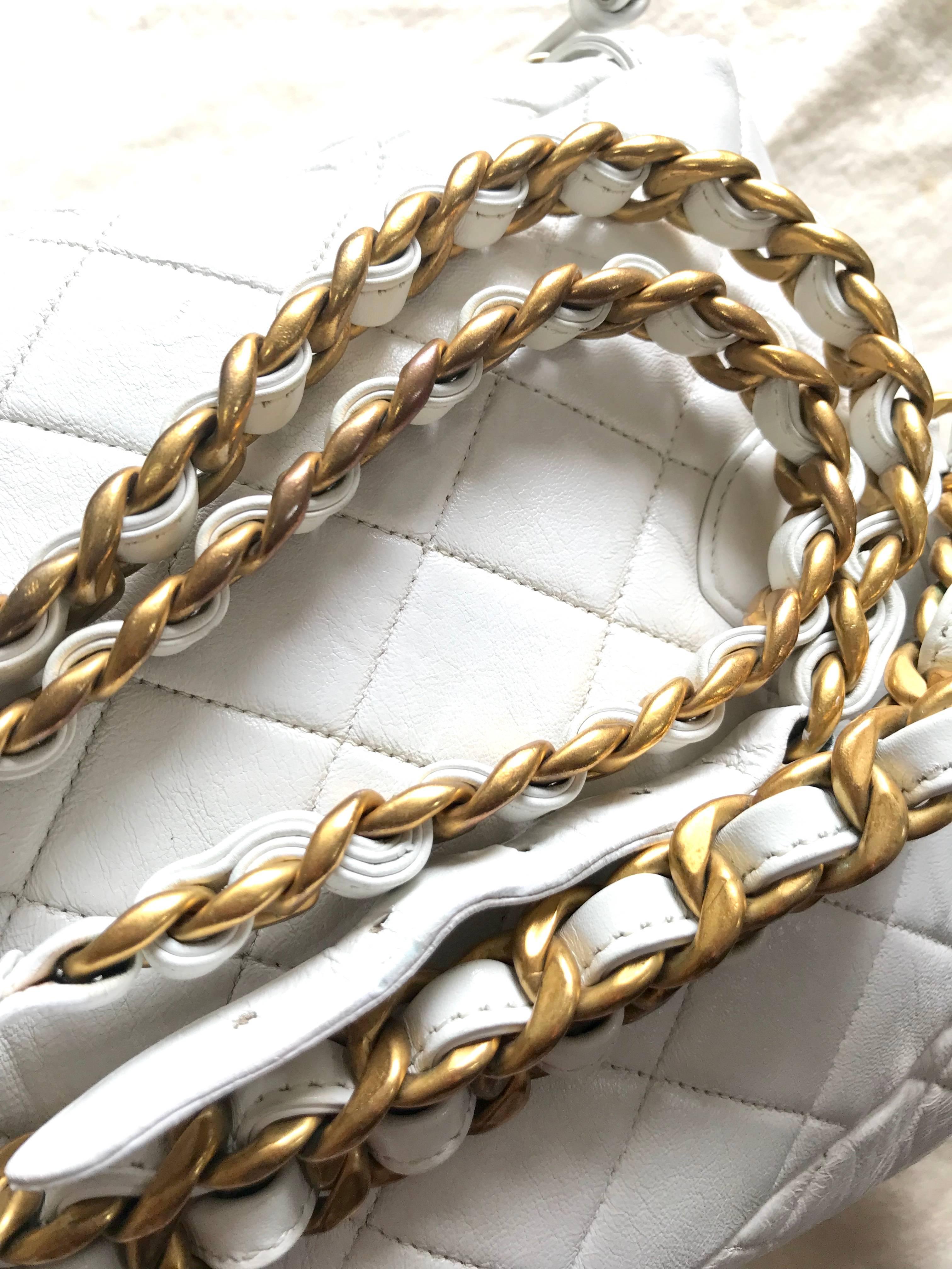 Women's Vintage CHANEL white lamb leather backpack with golden chain and CC closure.