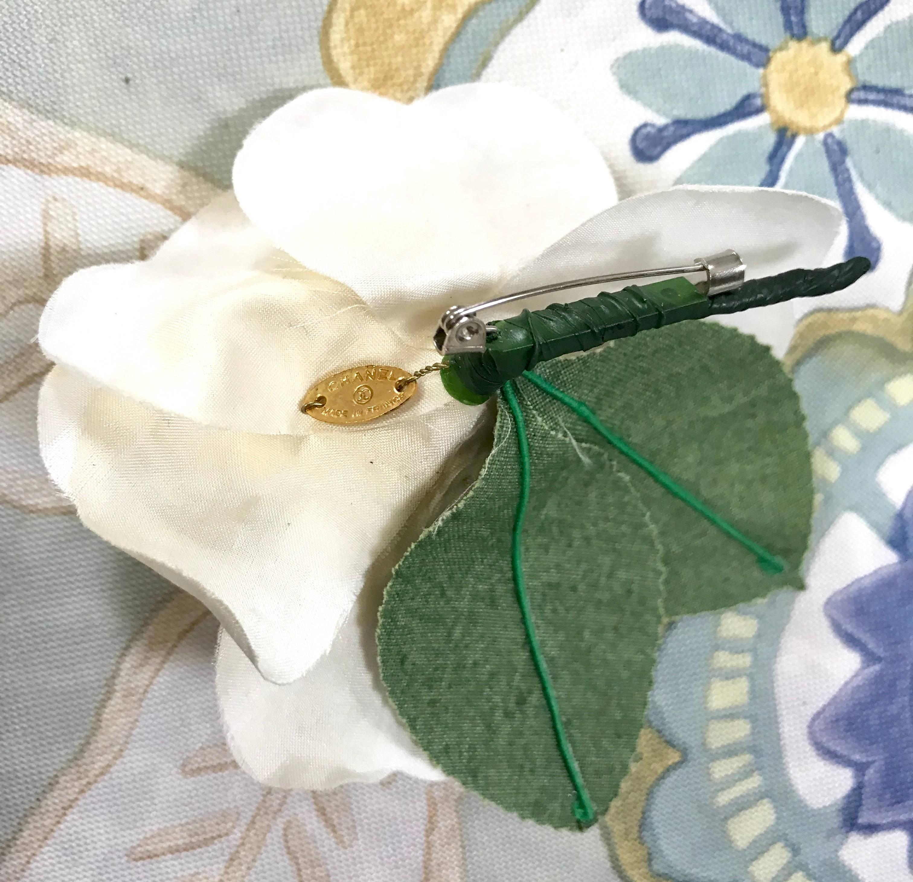 Vintage CHANEL ivory white silk camellia flower brooch with green leaves.  1