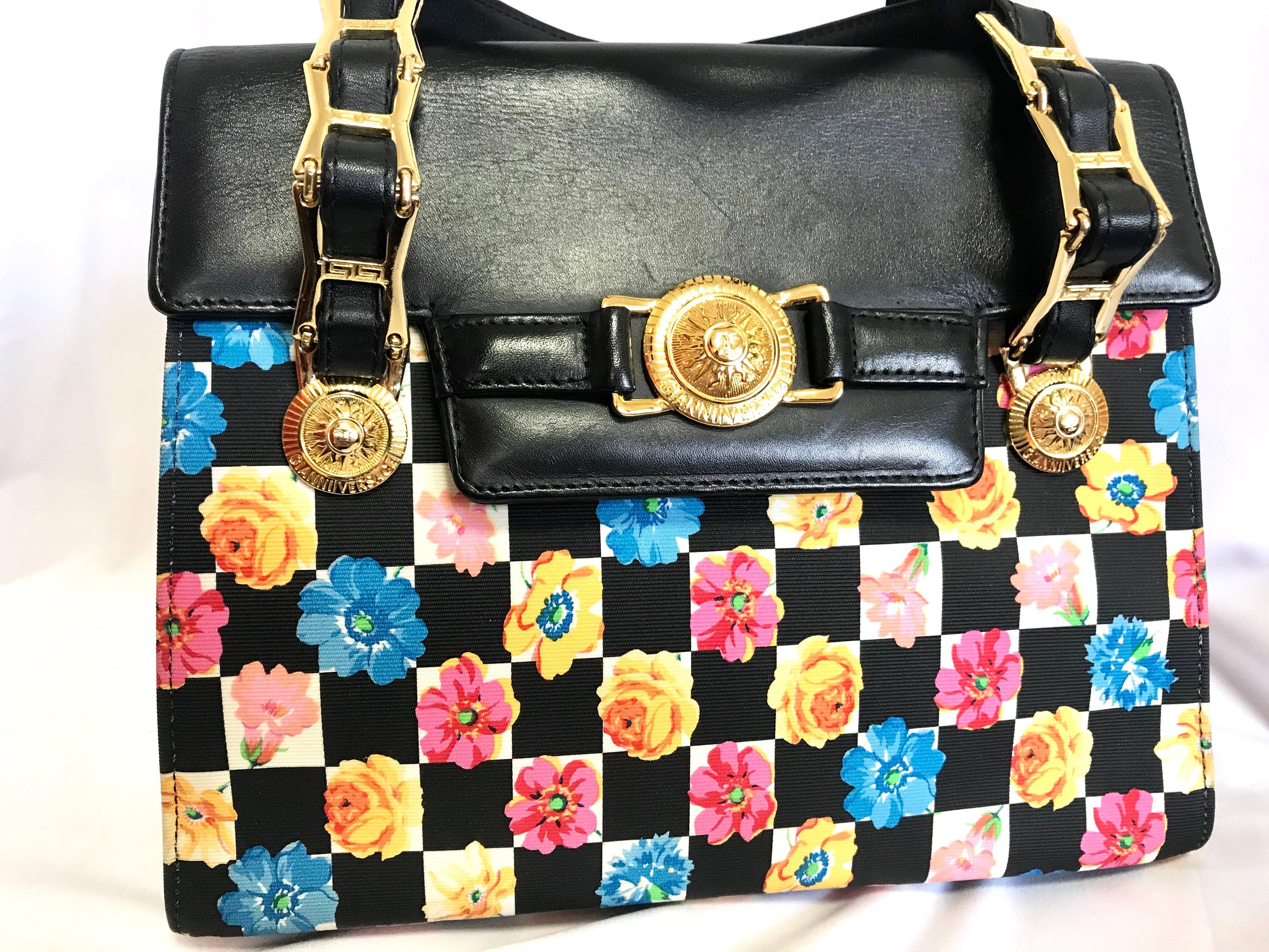 1990s. Vintage Gianni Versace black leather and pink, orange, and blue flower print handbag with golden hardware and sunburst motifs, Kelly handbag.

Introducing another rare vintage masterpiece from Gianni Versace back in the 90's.
If you are