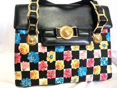 Vintage Gianni Versace black leather and pink, orange, and blue flower prints.