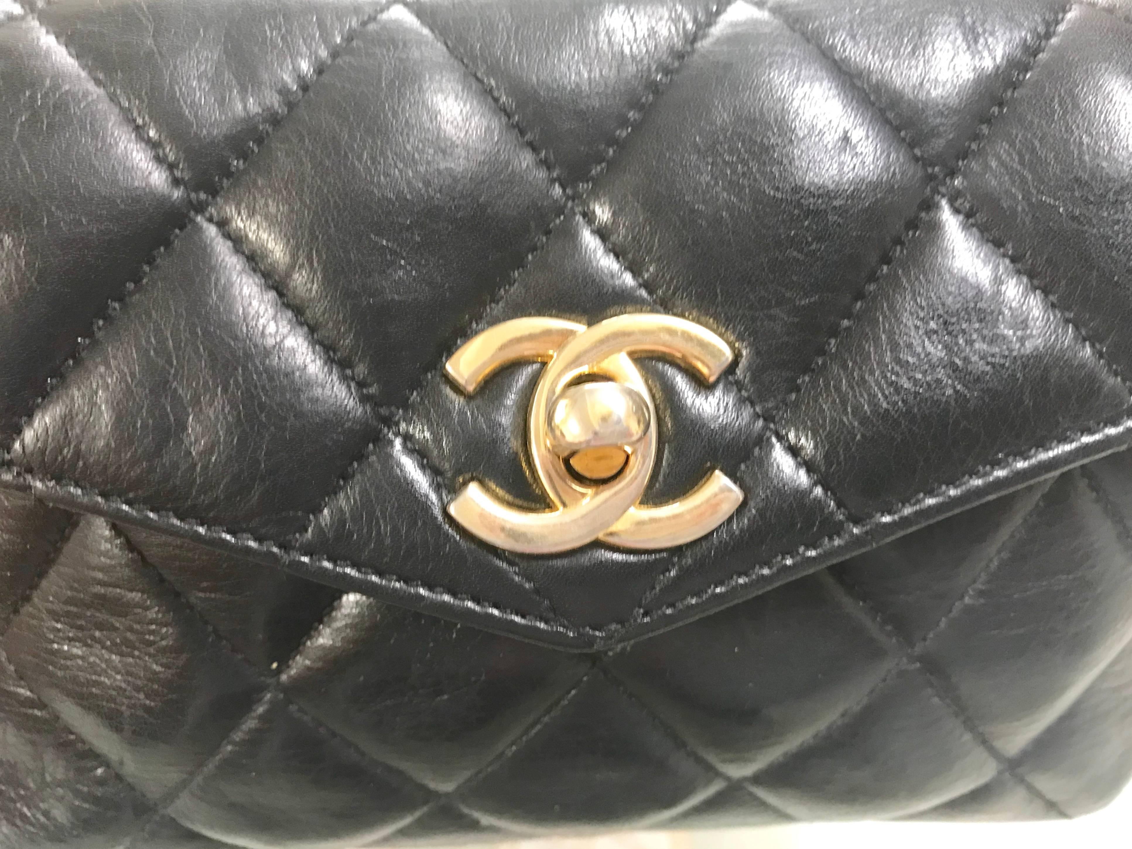 1980’s. Vintage CHANEL black lamb leather , belt bag, fanny pack with golden chain belt and CC closure hock. Belt size good for 26