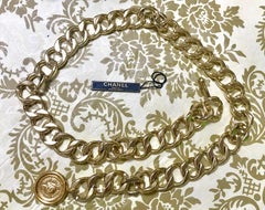 MINT. Vintage CHANEL golden thick chain belt with CC and mademoiselle charm.
