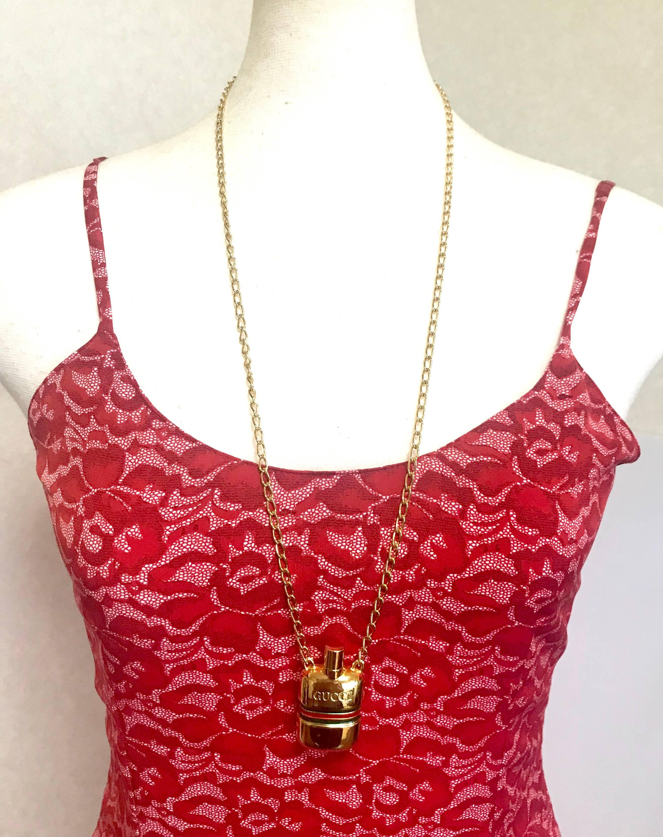 1980s. MINT. Vintage Gucci golden mini perfume, eau de cologne bottle necklace with embossed logo and webbing sherry line. Gorgeous jewelry.

Great vintage Gucci jewelry gift!
Introducing a rare vintage mini perfume/eau de cologne bottle necklace