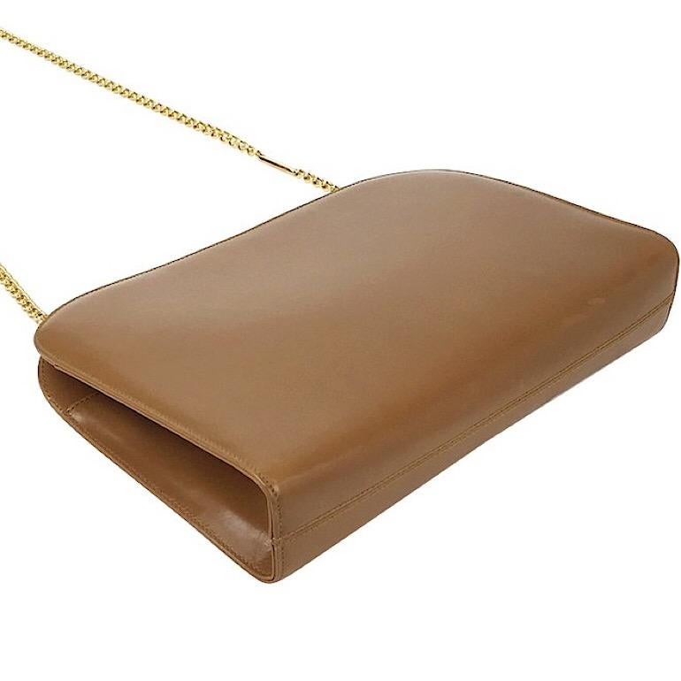 1990s. Vintage Salvatore Ferragamo brown leather shoulder purse with gold tone chain from gancini collection. Classic bag from Ferragamo.

This is a vintage Salvatore Ferragamo's genuine brown leather shoulder purse from its signature, Gancini