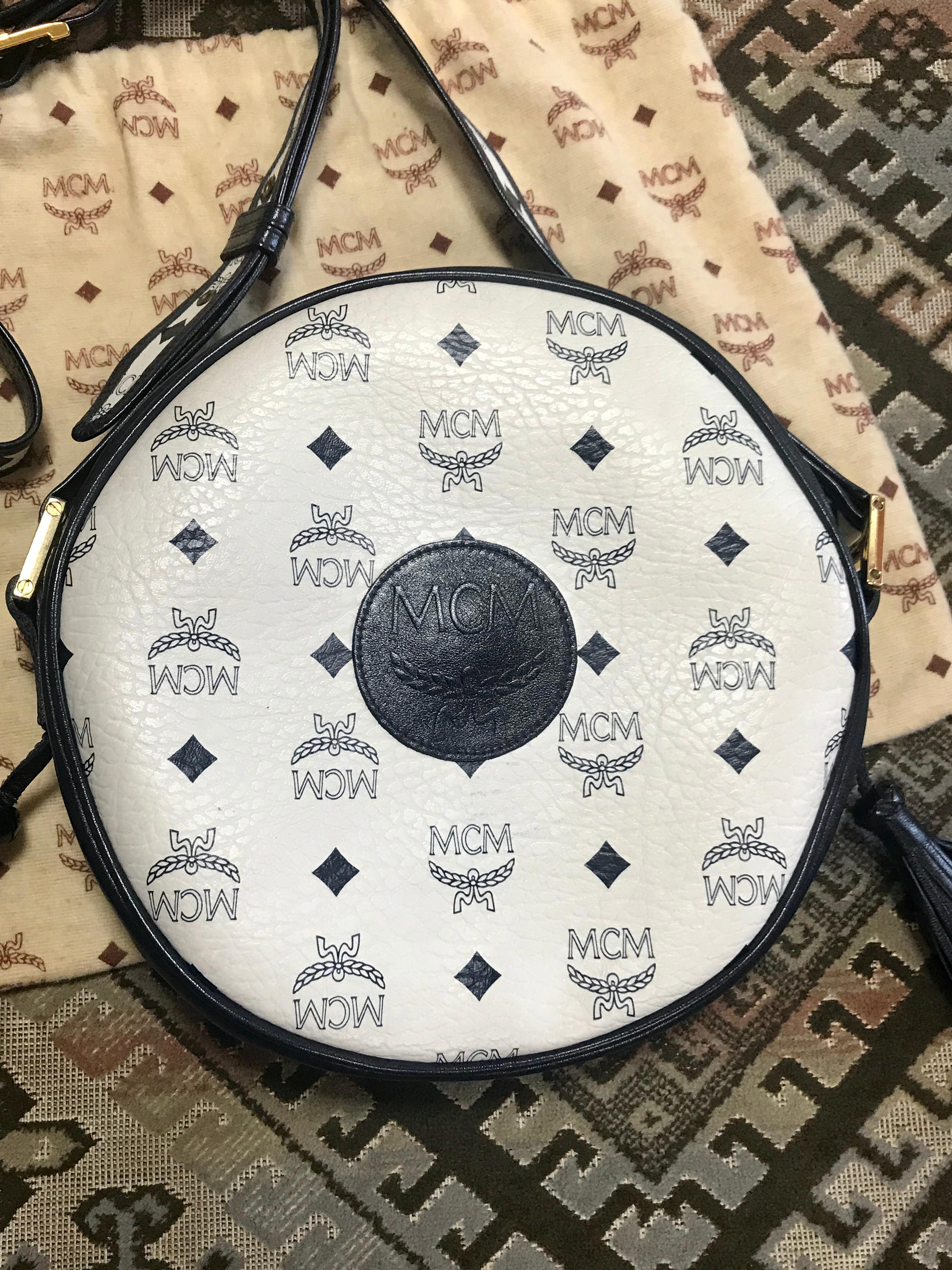 MINT/Excellent vintage condition! 
1980s. Vintage MCM navy and white monogram round shape Suzy Wong shoulder bag with leather trimmings. Unisex purse Designed by Michael Cromer.

MCM has been back in the fashion trend again!!
Now it's considered to