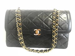 Vintage Chanel black 2.55 double flap chain bag with gold and silver CC.  Paris