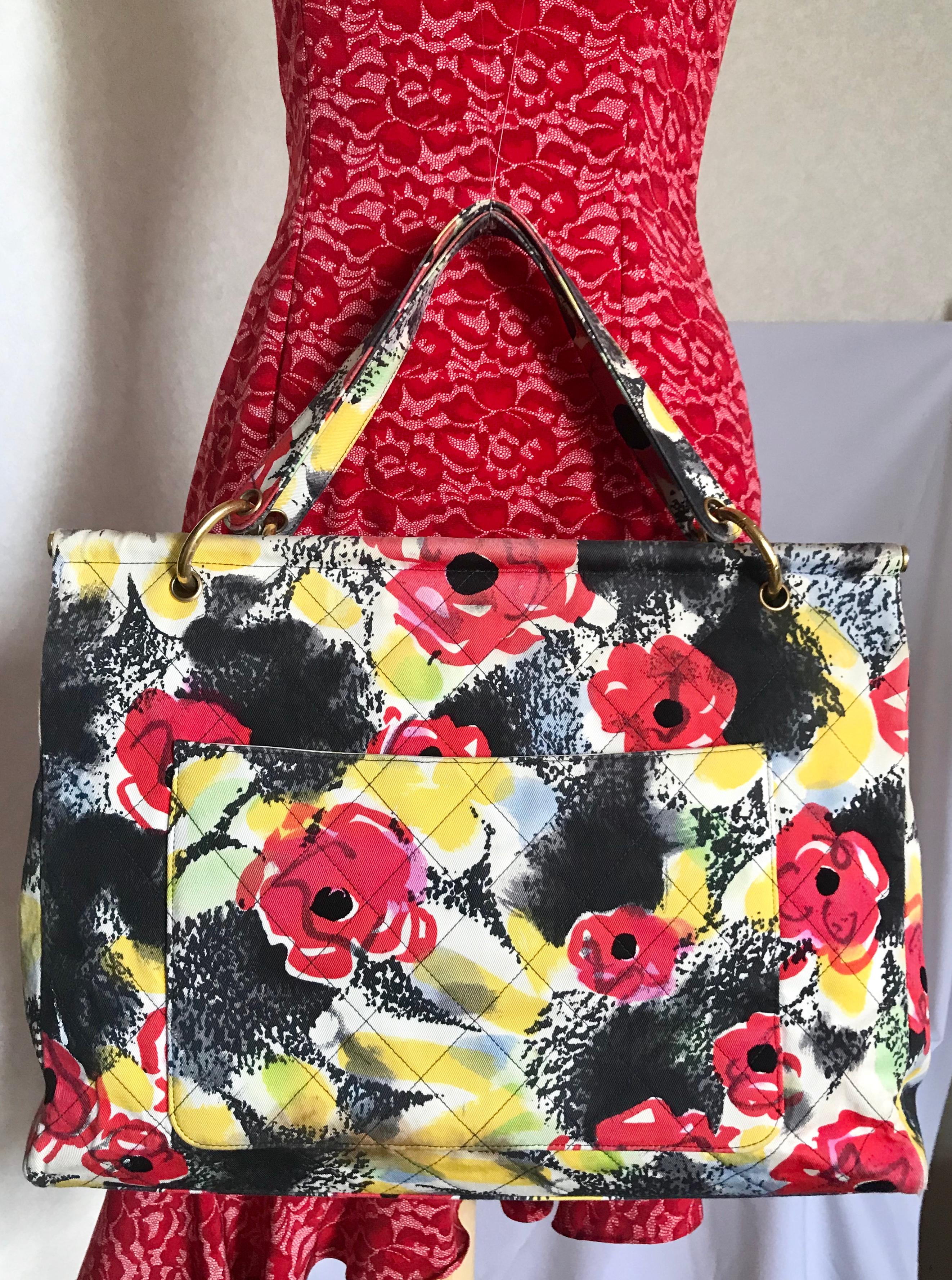 1990s. Vintage CHANEL red flower, yellow, and black water color drawing print design fabric canvas large tote bag with black enamel CC mark. Rare masterpiece back in the 90’s.

Introducing one of the rarest vintage CHANEL bags back in the