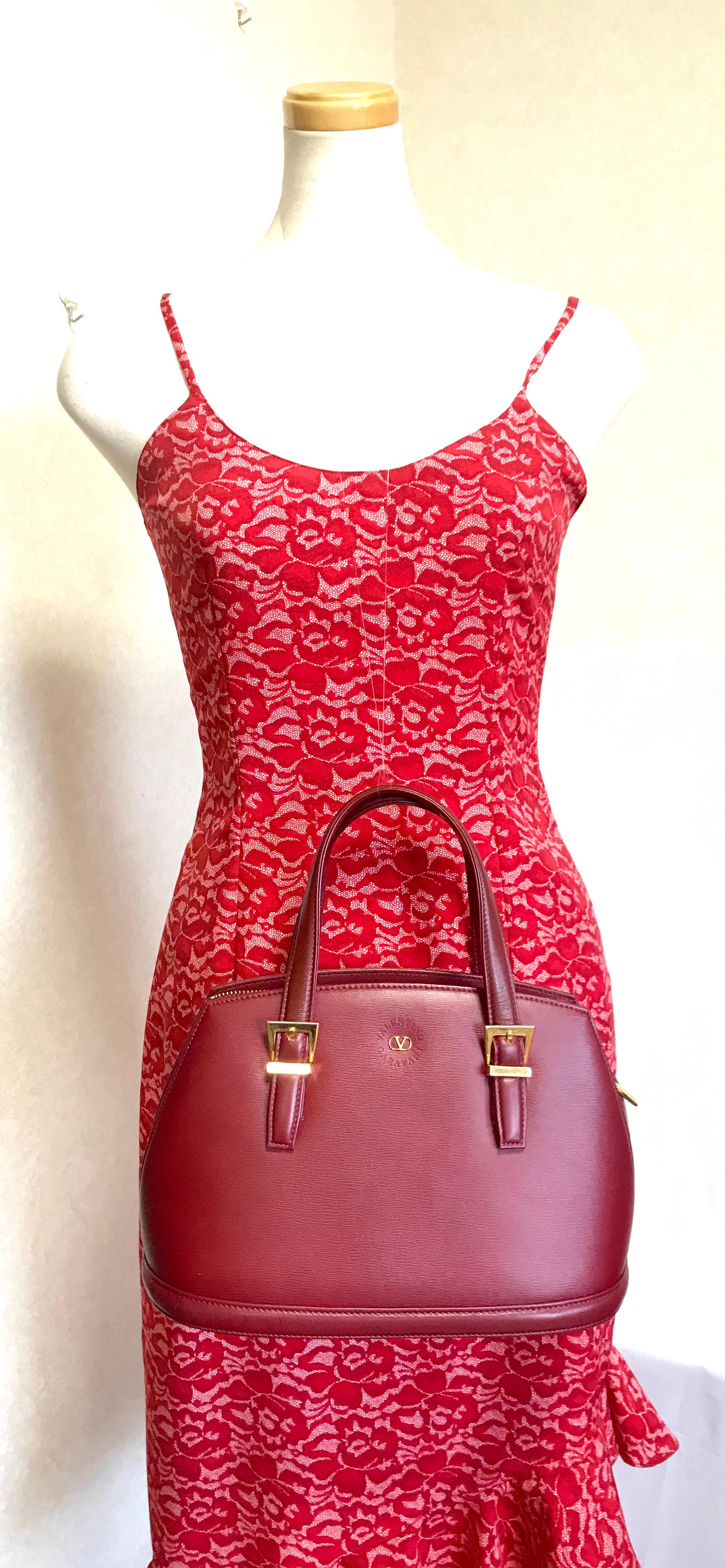 1990s. Vintage Valentino Garavani wine leather handbag with golden buckles. Classic Valentino purse for any occasions.

This is the vintage Valentino Garavani wine/bordeaux leather purse from 90's.
Classic style that fits any occasions such as