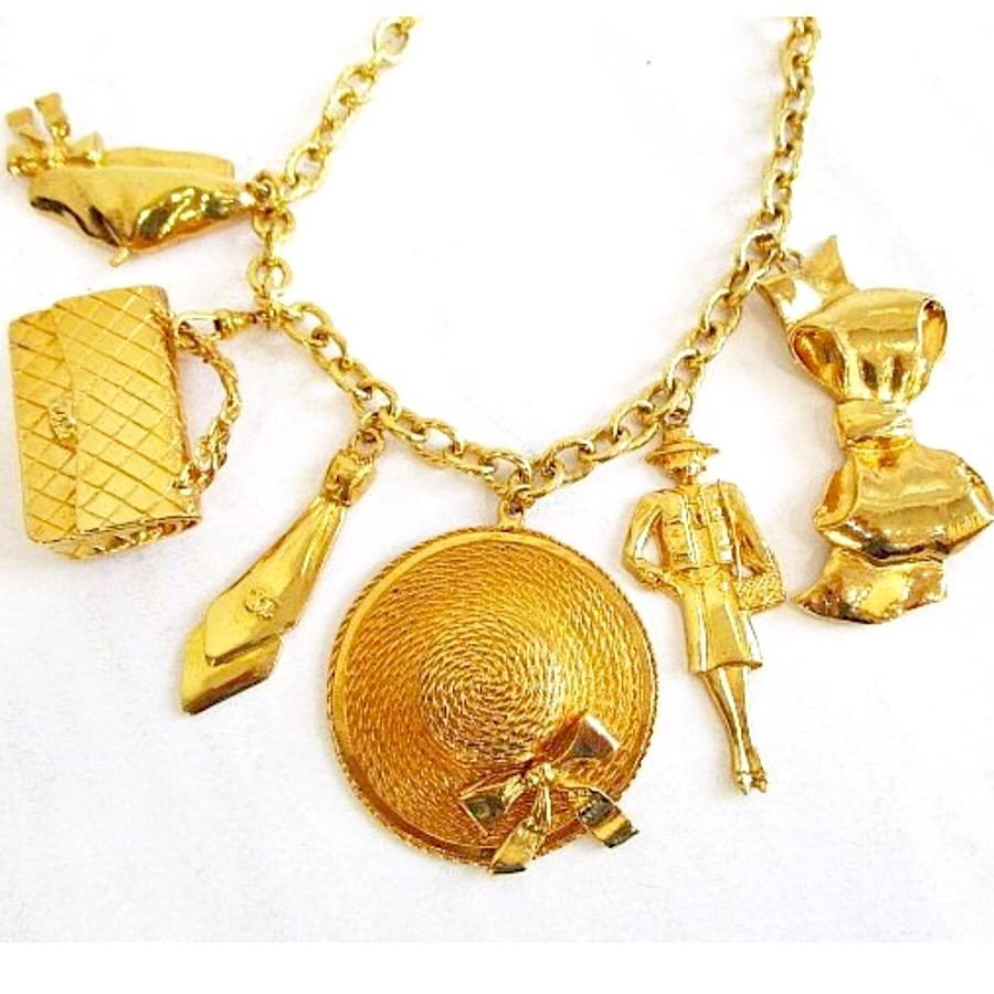 1990s. Vintage Chanel gold tone chain necklace with large motifs, 2.55 bag, mademoiselle, shoes, tie, hat and bow charms dangling pendant top.

If you are looking for a vintage jewelry from Chanel back in the old era, then this is the