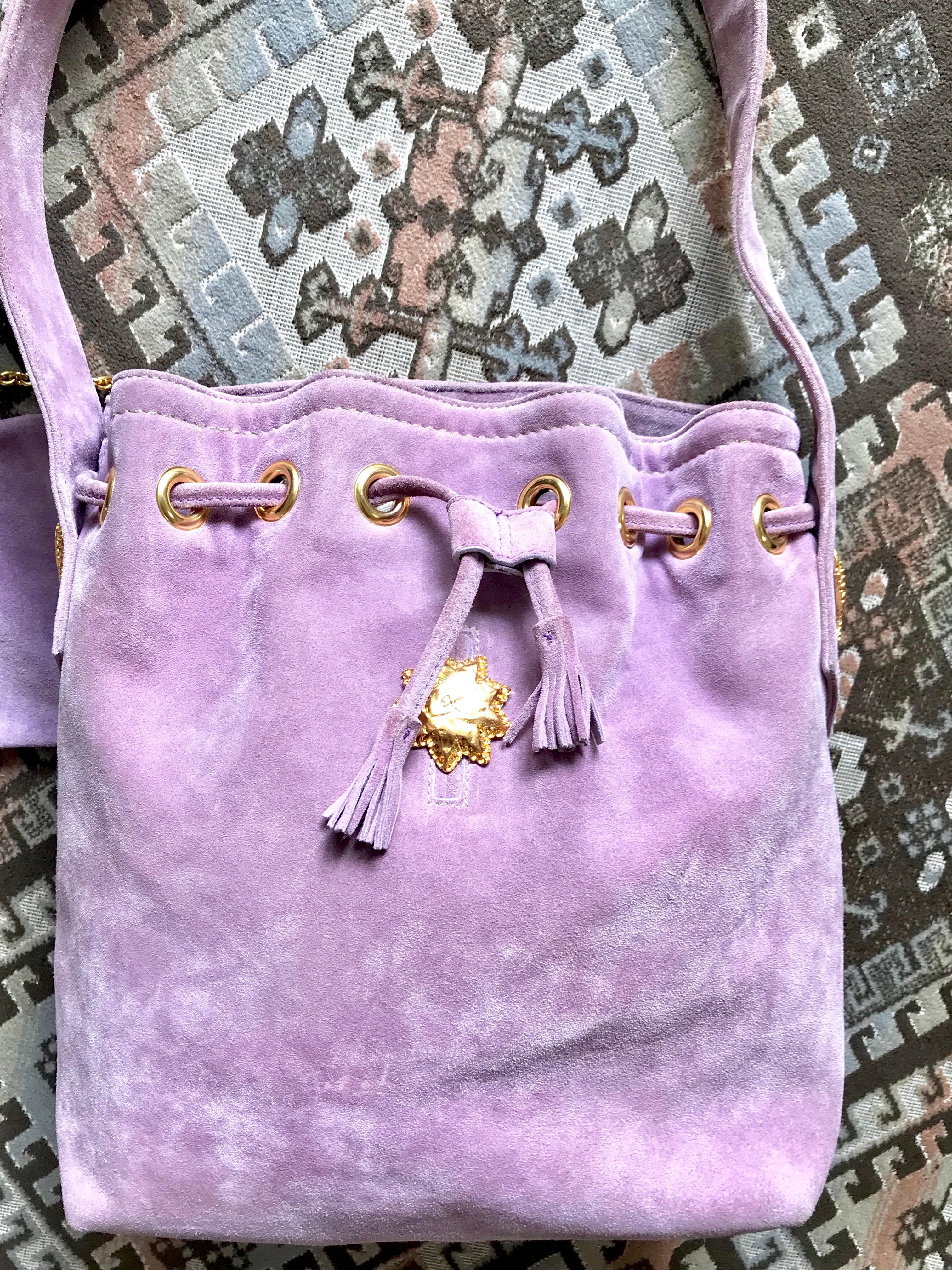 1990s. Vintage Christian Lacroix purple suede leather hobo bucket shoulder bag with drawstrings and golden sun, heart etc.. motifs. 
Unique and beautiful masterpiece bag back in the 90's. Lacroix purse to make you look sophisticated chic and