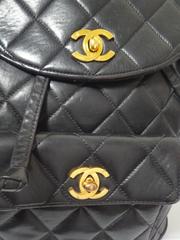 Vintage CHANEL quilted black lamb leather backpack with gold chain strap and CC