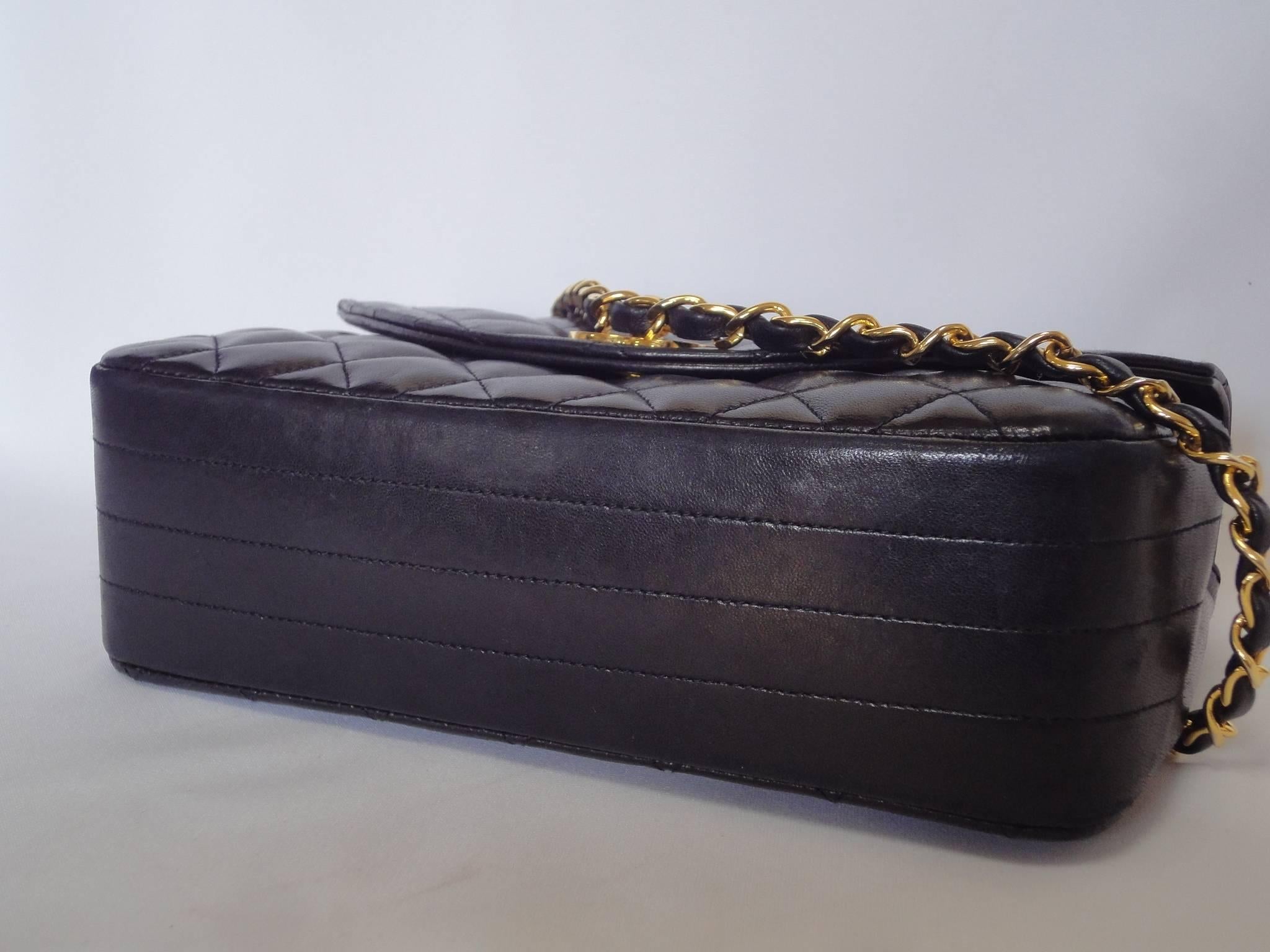 Black 1980s vintage Chanel black lamb leather 2.55 classic oval flap shoulder bag.