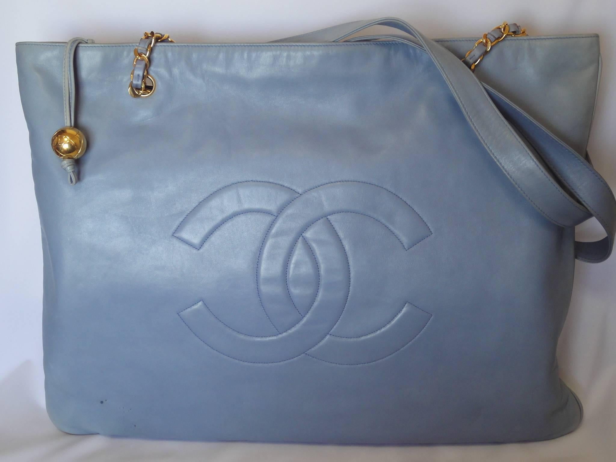 Vintage CHANEL milky blue calf leather extra large chain shoulder tote bag with gold tone CC ball motif. Rare color purse. Limited edition.

Introducing another vintage CHANEL milky blue calfskin extra large tote bag with gold tone chain handles and