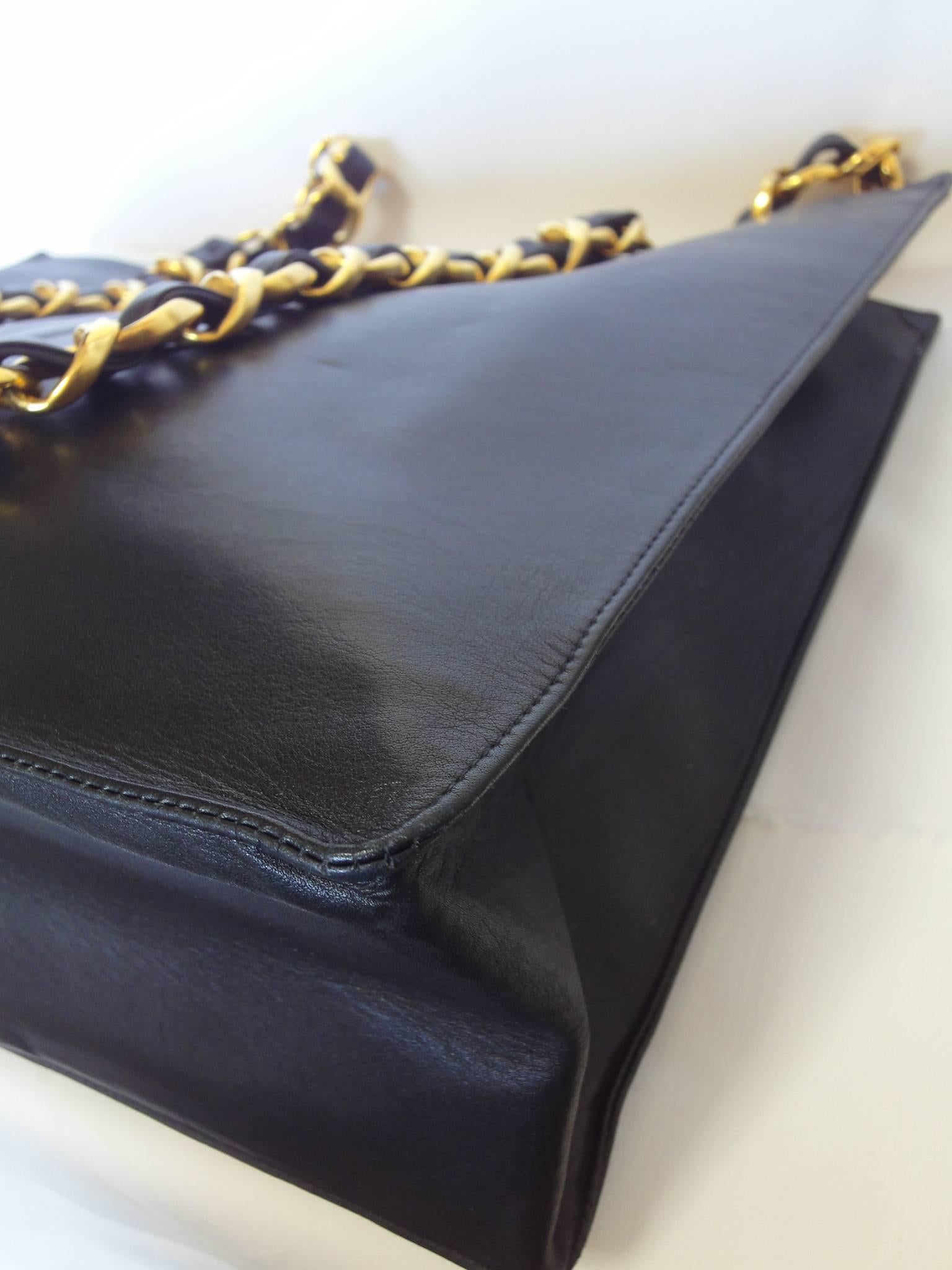 Vintage CHANEL black calfskin large tote bag with gold tone chain handles and CC 1
