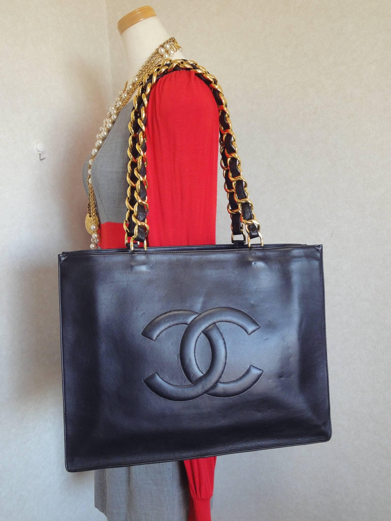 Vintage CHANEL black calfskin large tote bag with gold tone chain handles and CC 5