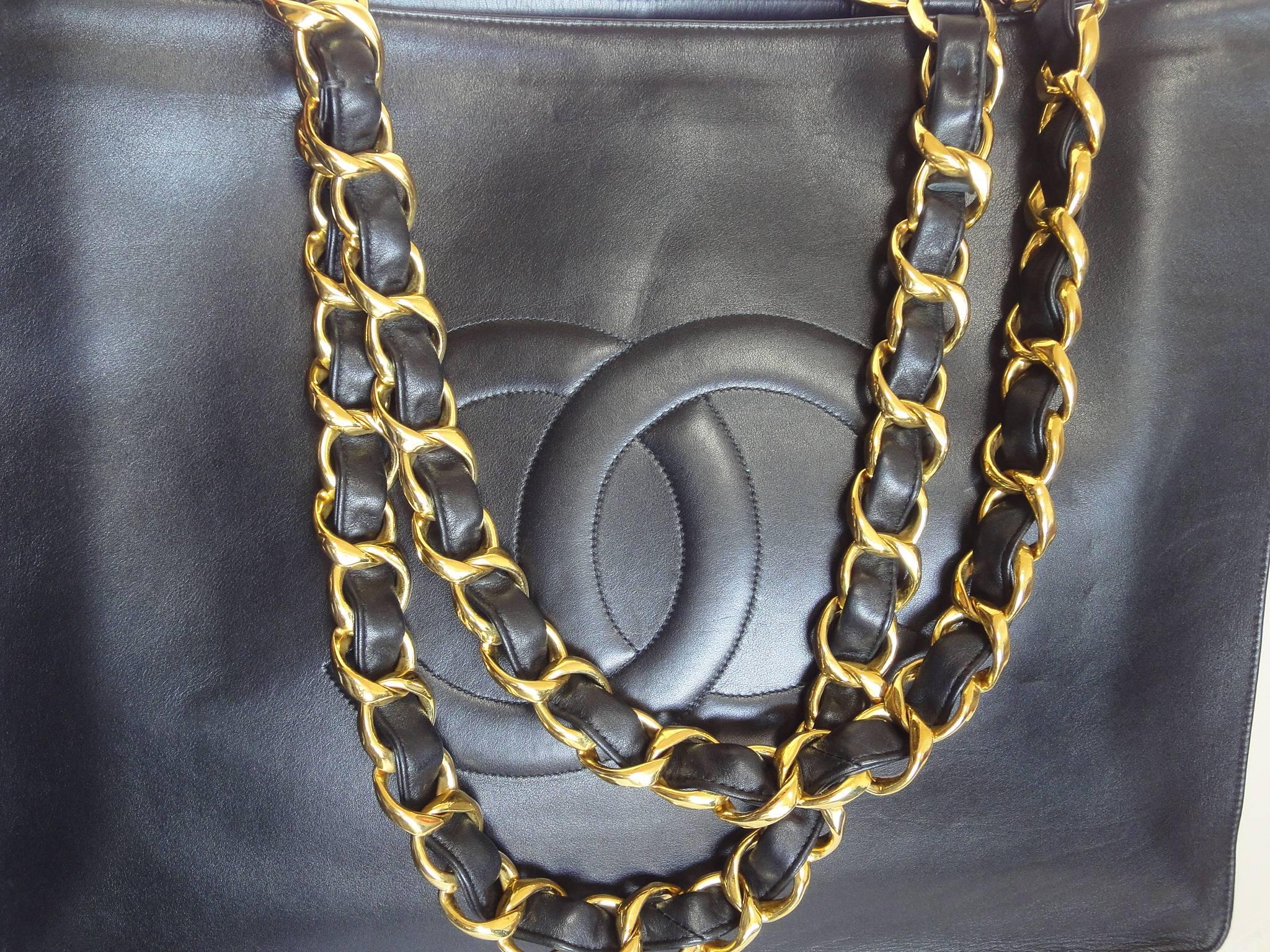 Vintage CHANEL black calfskin large tote bag with gold tone chain handles and CC 4