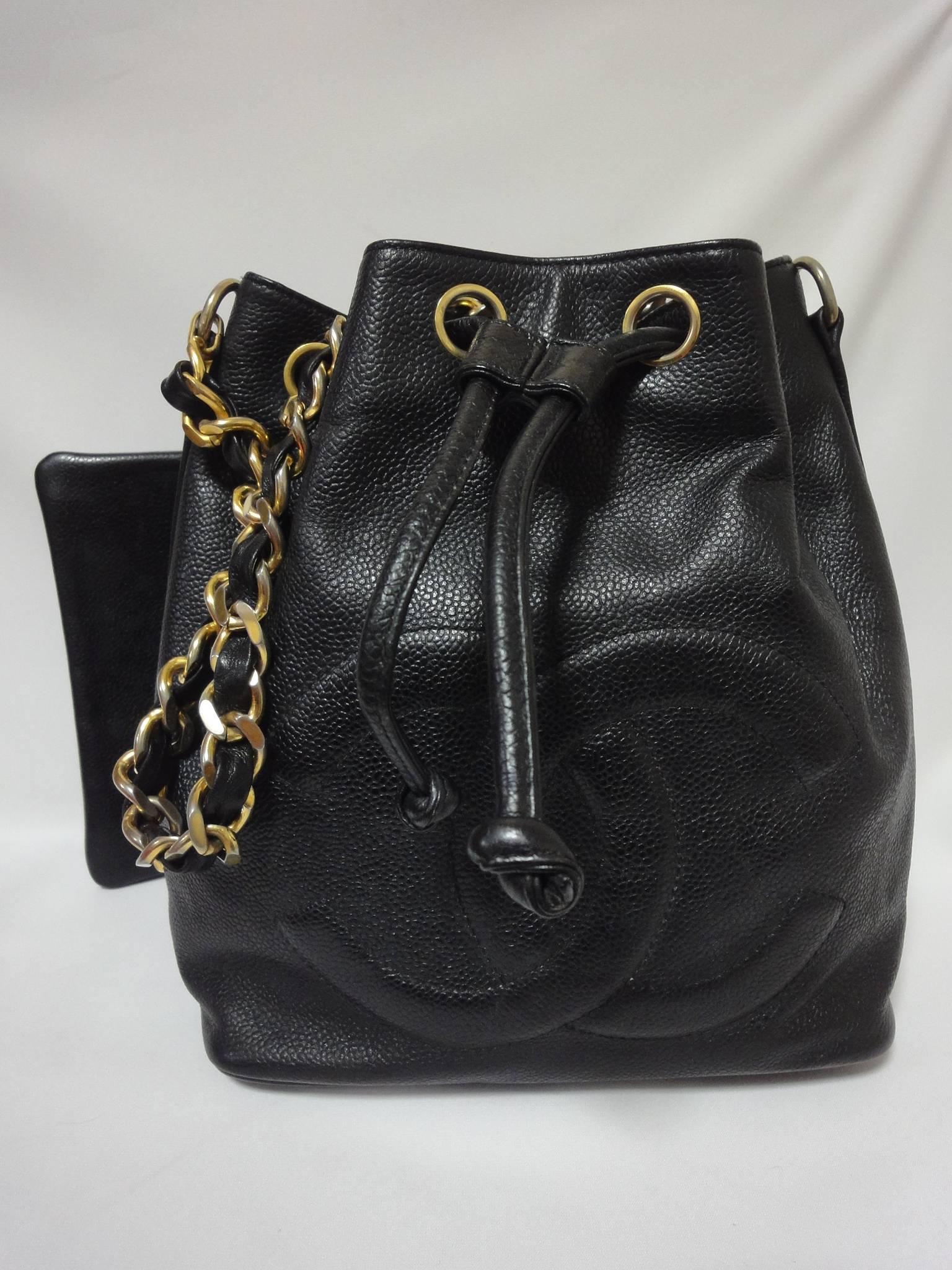 1990s Vintage CHANEL black caviar leather hobo bucket shoulder bag with golden chain strap, drawstrings, and CC stitch mark.

Introducing another adorable vintage masterpiece from CHANEL back in the early 90s.
Black bucket hobo shoulder bag in