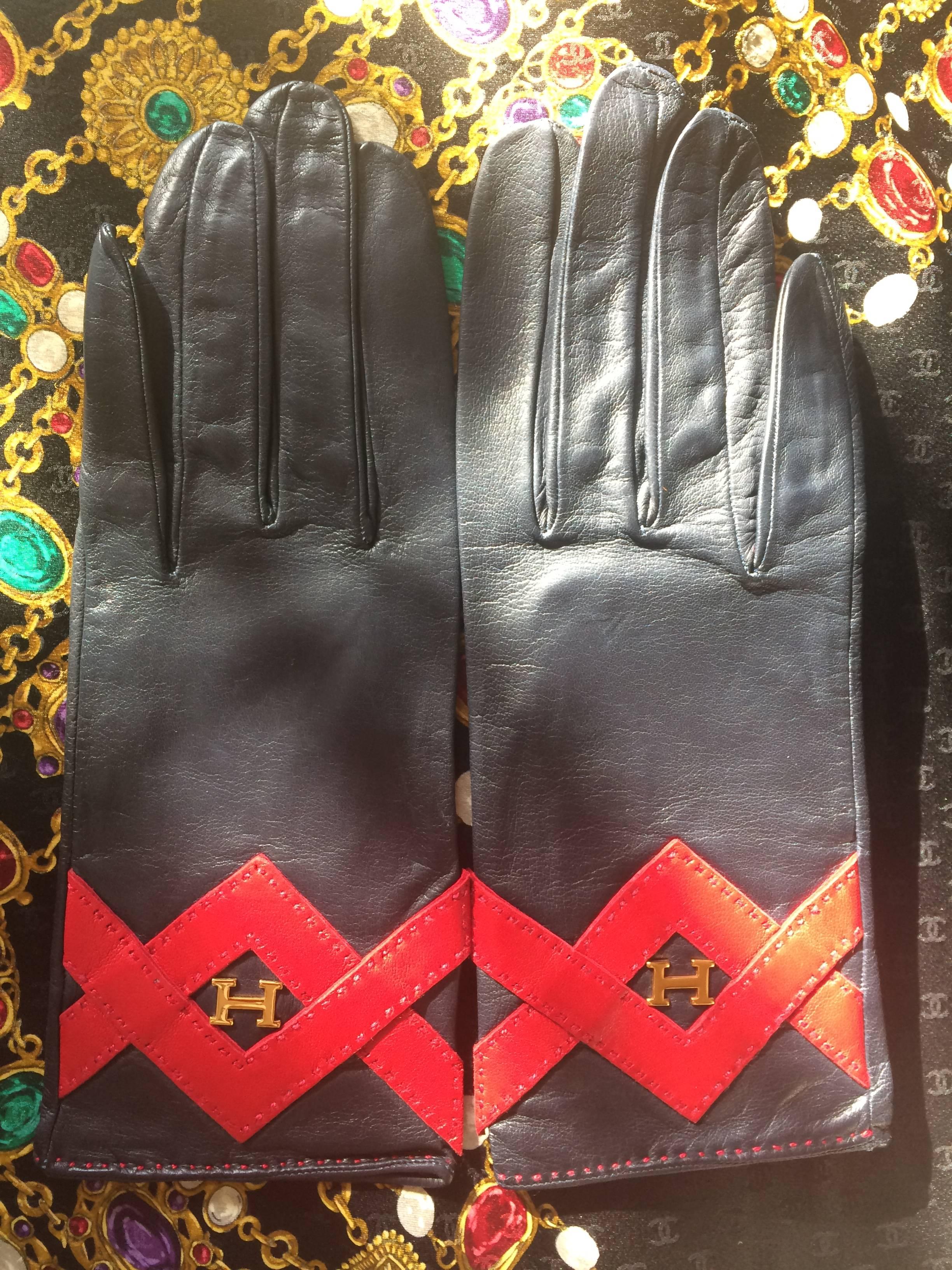 Vintage HERMES black lambskin gloves with golden　H logo with red triangle stitch design. Perfect vintage gift for the season. size 7.5

Introducing a rare pair of Hermes genuine black lambskin gloves from the early 90's. Size 7.5 
Beautiful