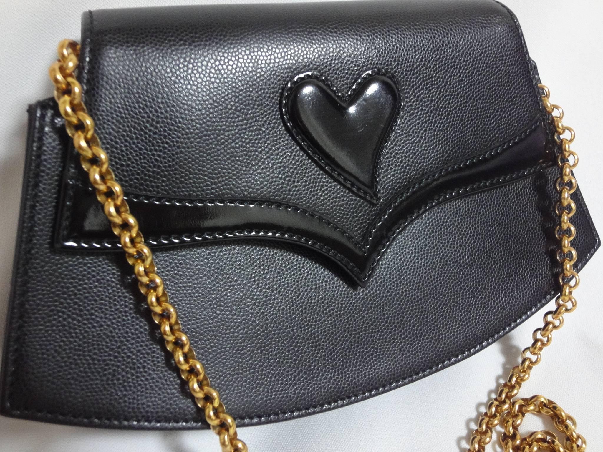 MINT. Vintage Christian Lacroix black leather pointy flap tip and heart motif, party clutch purse with golden chain strap. Hot masterpiece

This is a Christian Lacroix black party purse with a heart motif and golden chain strap. 
Cute trapezoid