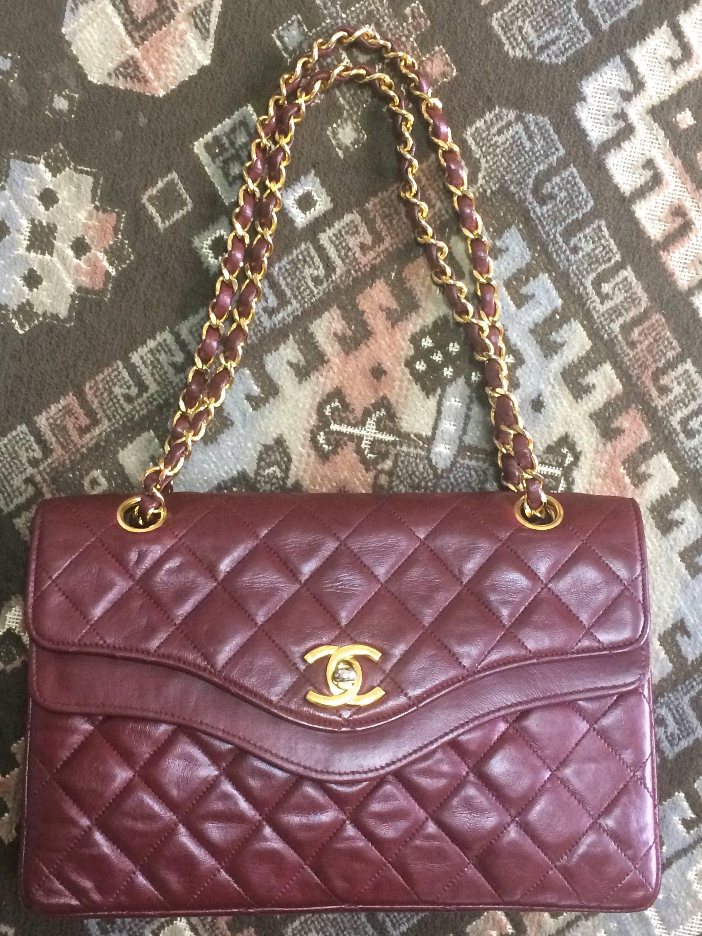 1970's, 1980's vintage Chanel wine lambskin rare design 2.55 purse with double flap and wavy flap design. One-of-a-kind bag.

Introducing another rare vintage Chanel bag, wine lambskin rare design 2.55 purse with double flap and wavy flap design.
