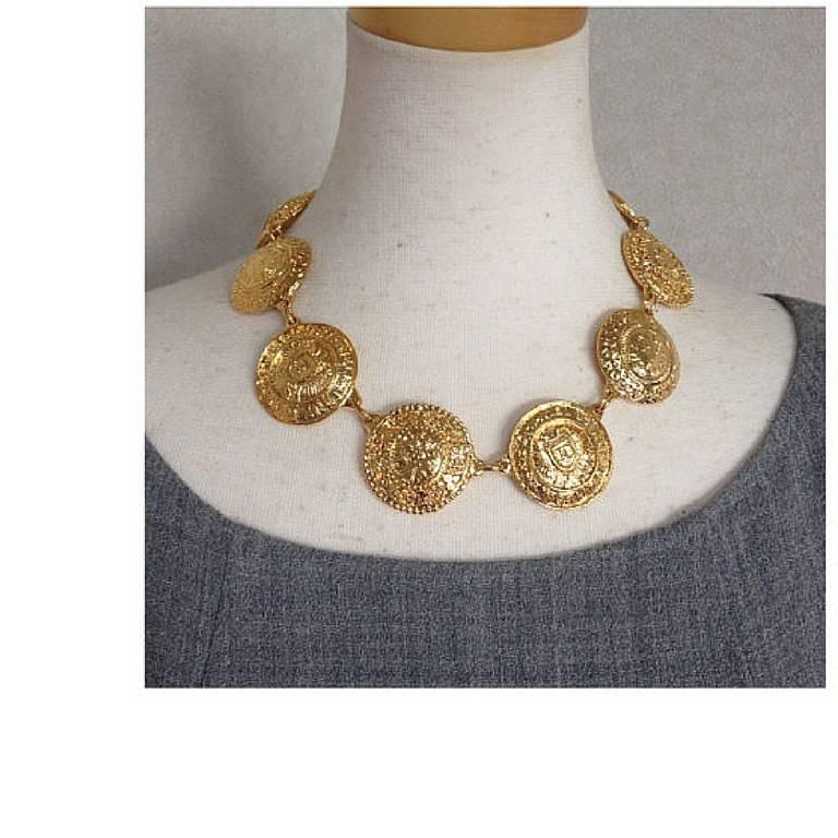 Vintage CHANEL rare statement necklace with logo embossed unique coin motif charms. Gorgeous masterpiece jewelry back in the old era.

Introducing one-of-a-kind vintage jewelry piece from Chanel, a gorgeous statement necklace with unique logo