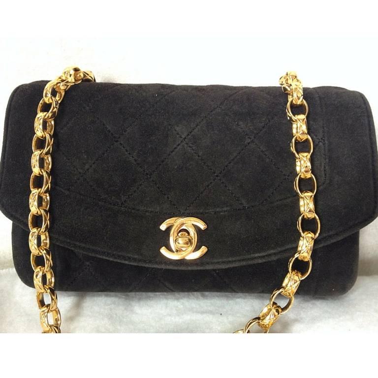 Vintage CHANEL charcoal black suede leather classic 2.55 shoulder purse with gold tone chain straps. Perfect daily use bag.

This is a vintage purse with gold chain strap from Chanel from the 90s.
Classic charcoal black suede leather classic 2.55