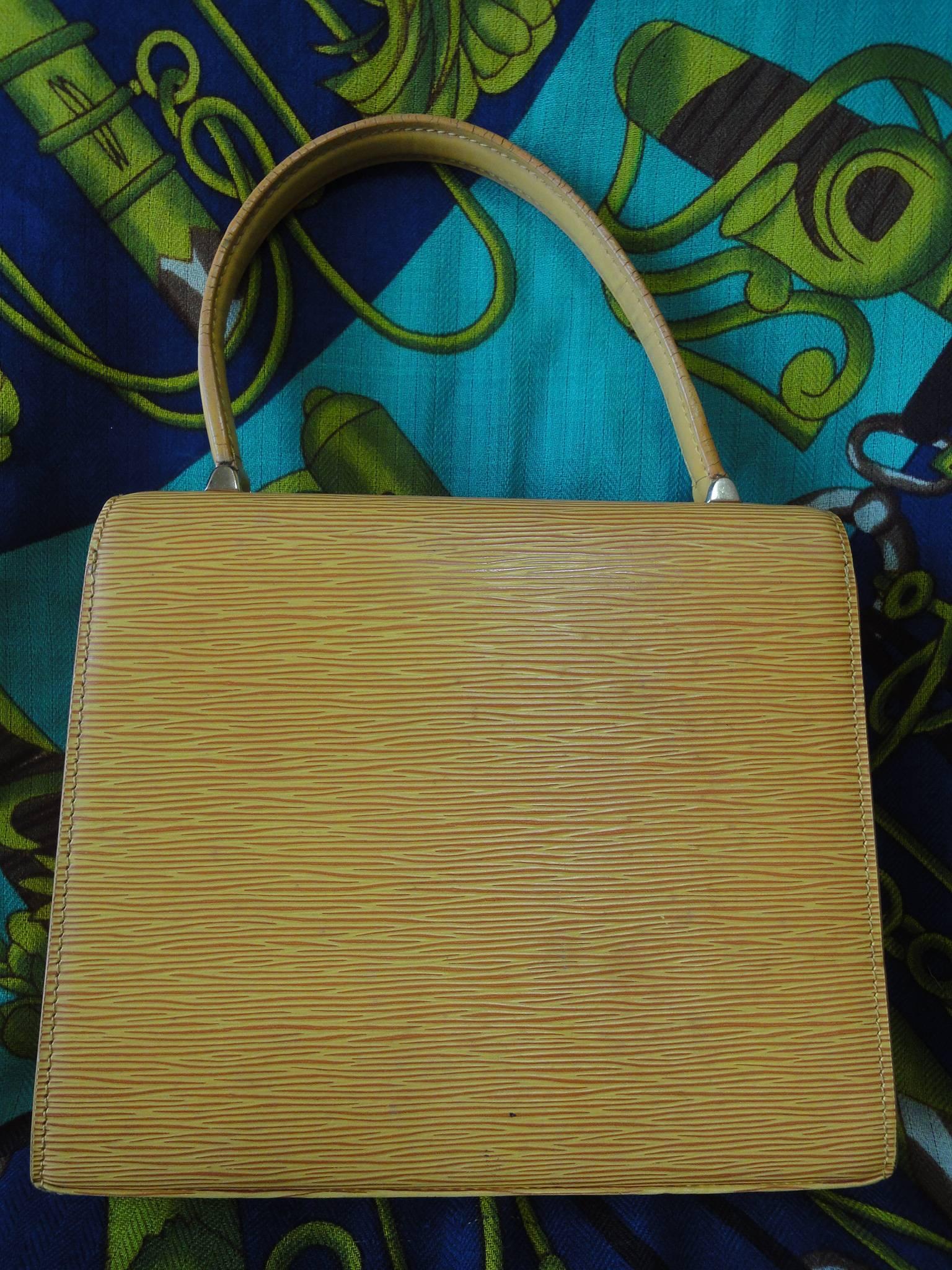 Vintage Louis Vuitton yellow epi Malesherbes handbag. Classic purse for Spring and summer season. Happy color.

Introducing a vintage Louis Vuitton purse in elegant kelly handbag shape, Malesherbes in happy fortune color of yellow epi.
The front