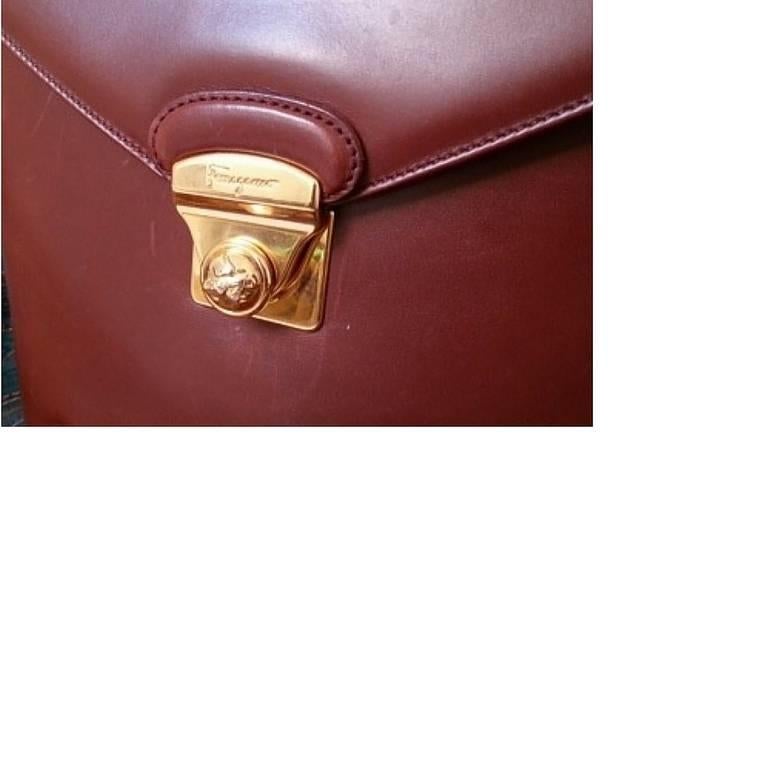 Vintage Salvatore Ferragamo brown leather trapezoidal shape purse with gold tone elegant closure. Ferragamo charms.

This is one of the rarest vintage Salvatore Ferragamo's pieces in genuine leather marron brown purse. Very rare design but yet