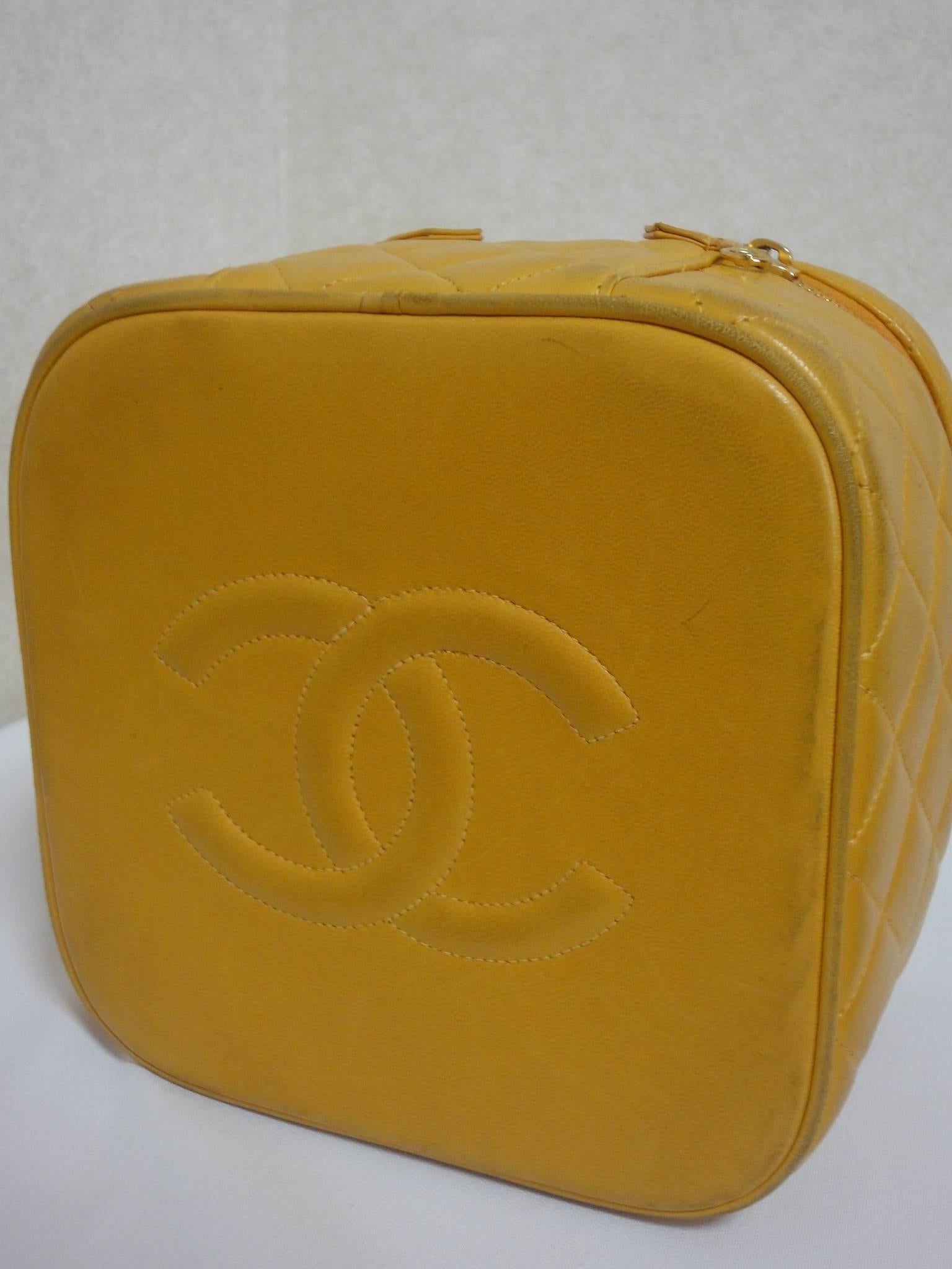 Vintage CHANEL yellow quilted lambskin cosmetic, make up case, vanity bag with CC mark at bottom. Can be a mini handbag. Get a lucky color.

Introducing a vintage CHANEL yellow color mini vanity bag that can be a multi-purpose purse such as