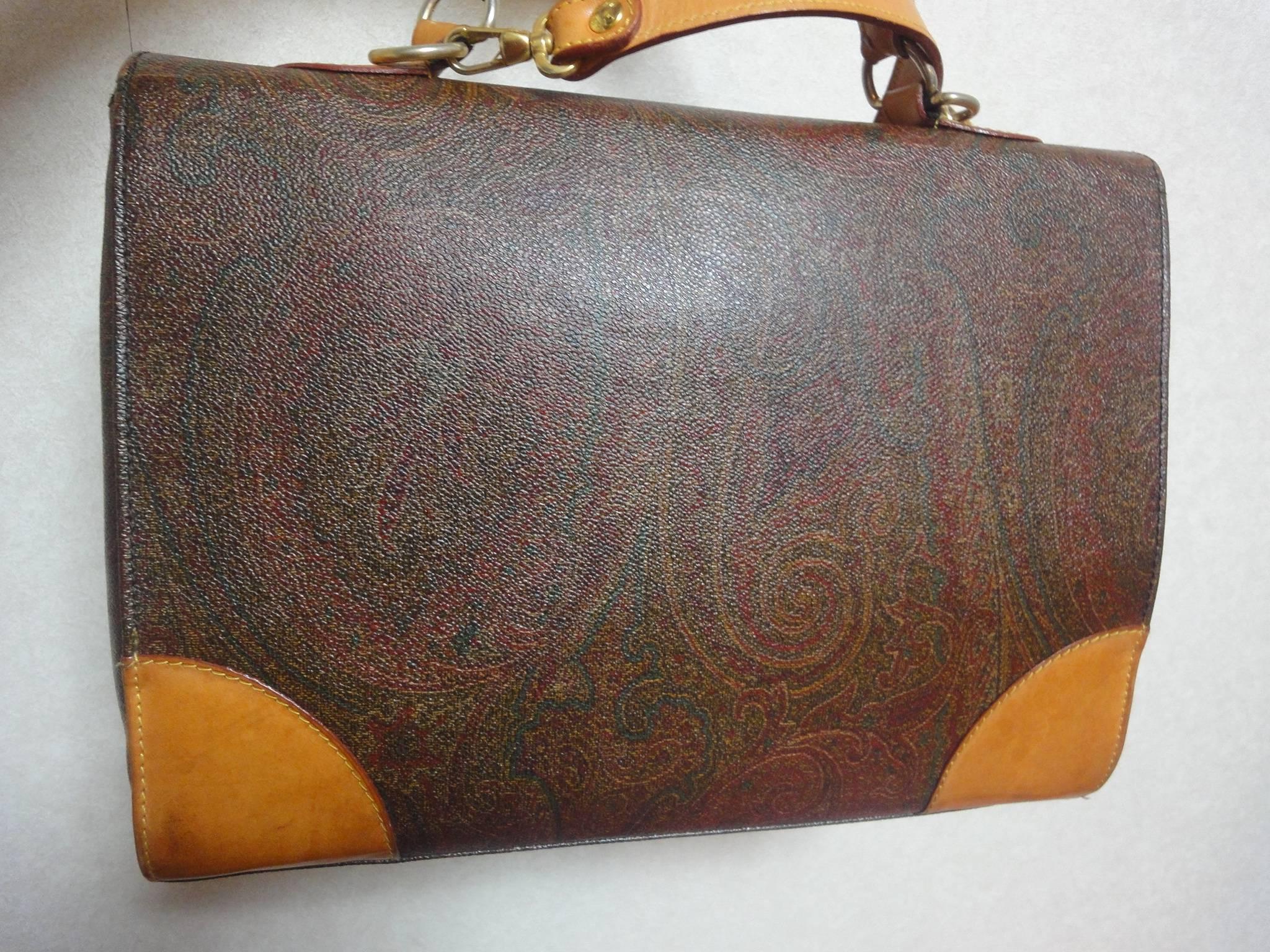 Vintage ETRO iconic paisley pattern handbag purse with leather trimmings in document briefcase style. Classic unisex style.

This is a vintage purse from ETRO from the 90s. 
Featuring Etro's iconic pasley pattern all over. 
Classic handbag style